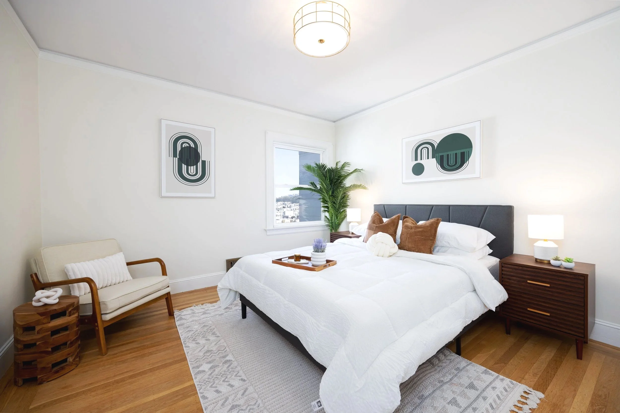 Modern bedroom with hard wood floors and fresh bedding