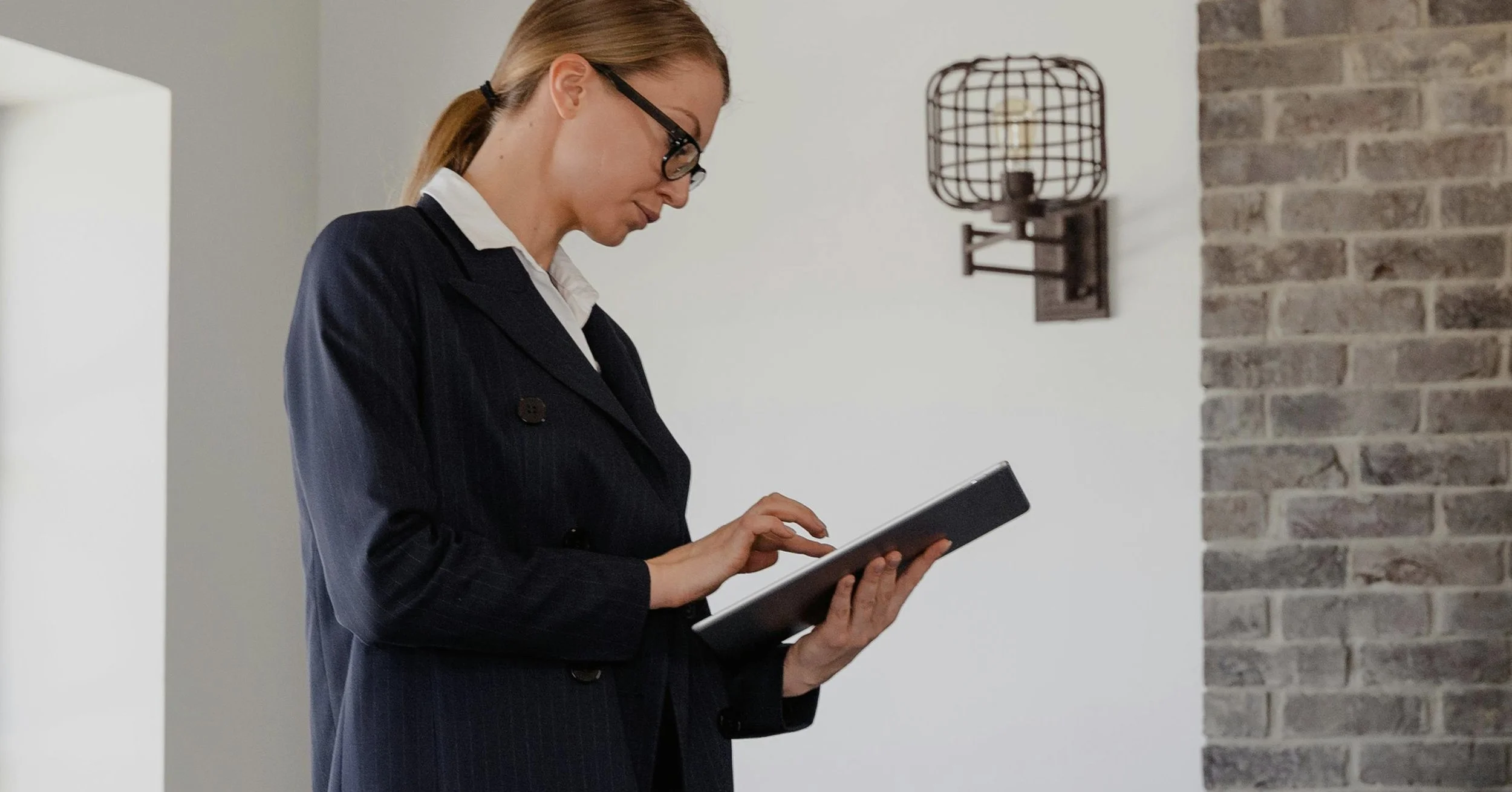 xReal estate project manager reviewing renovation details on a tablet during home preparation process