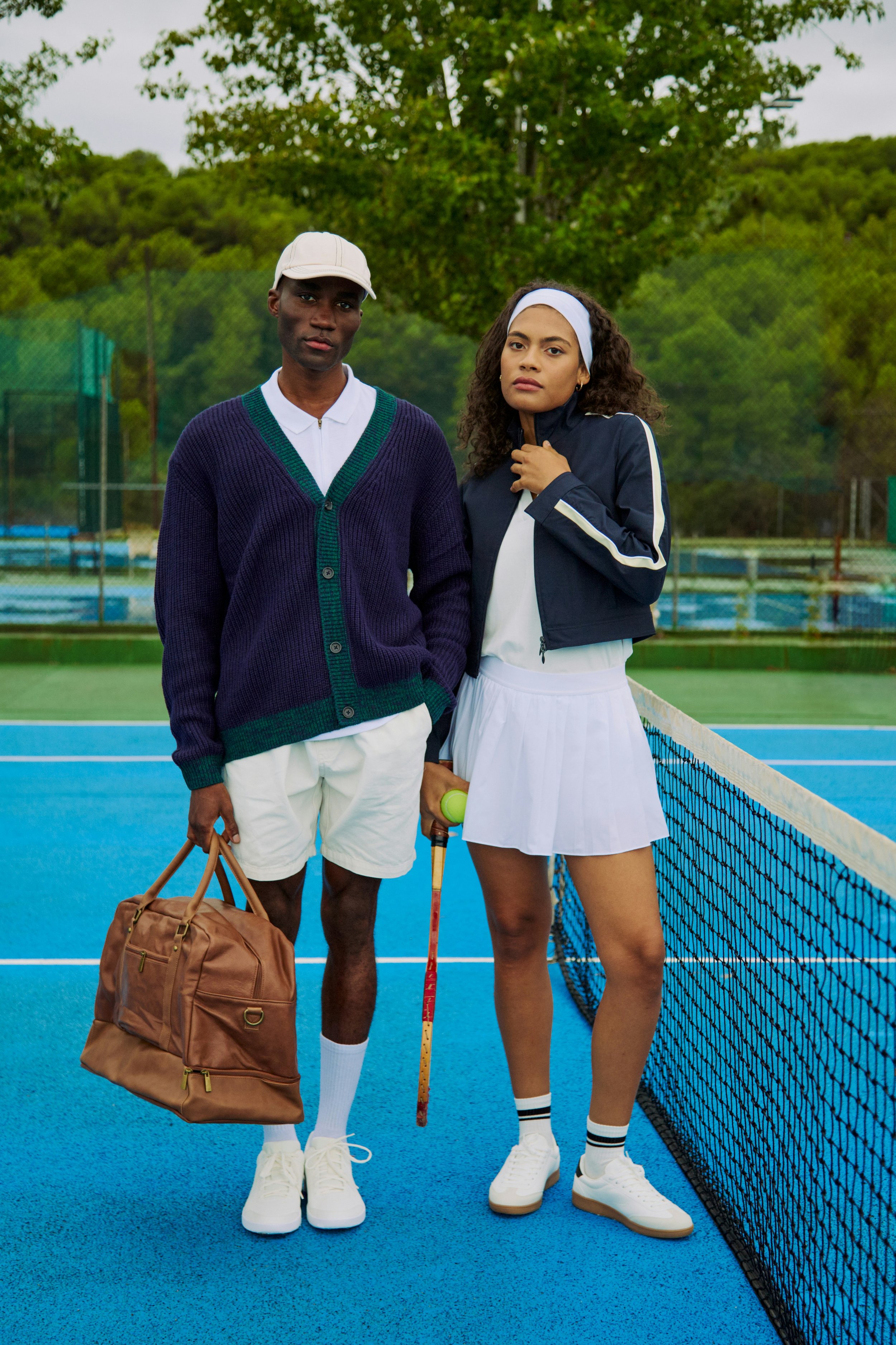 Lifestyle photo of two models in high end tennis sports apparel.