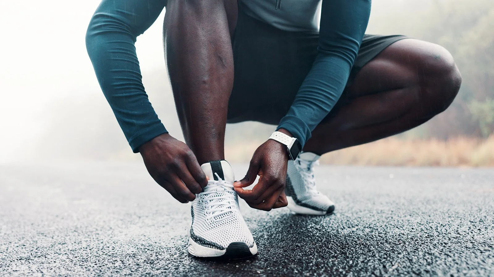 Man adjusts running shoes, lifestyle brand