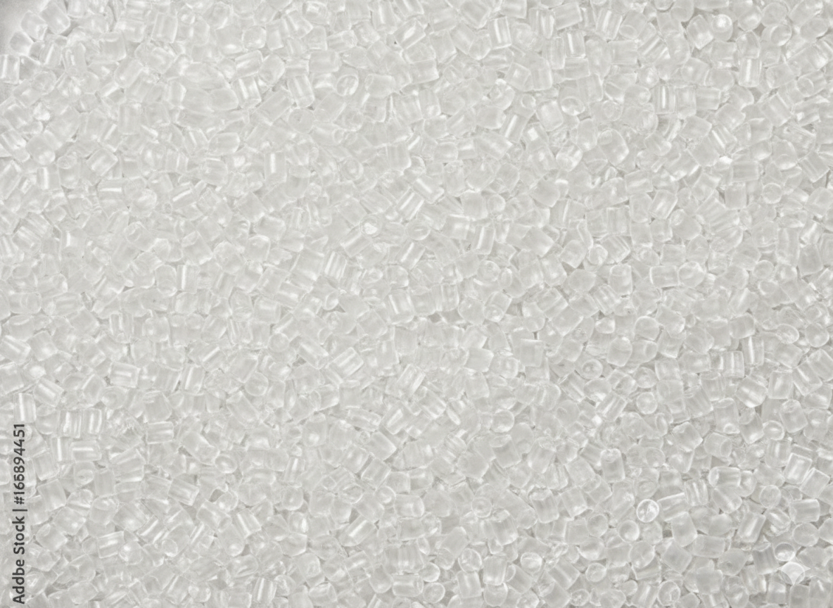 Close-up of numerous small, transparent plastic pellets or beads.
