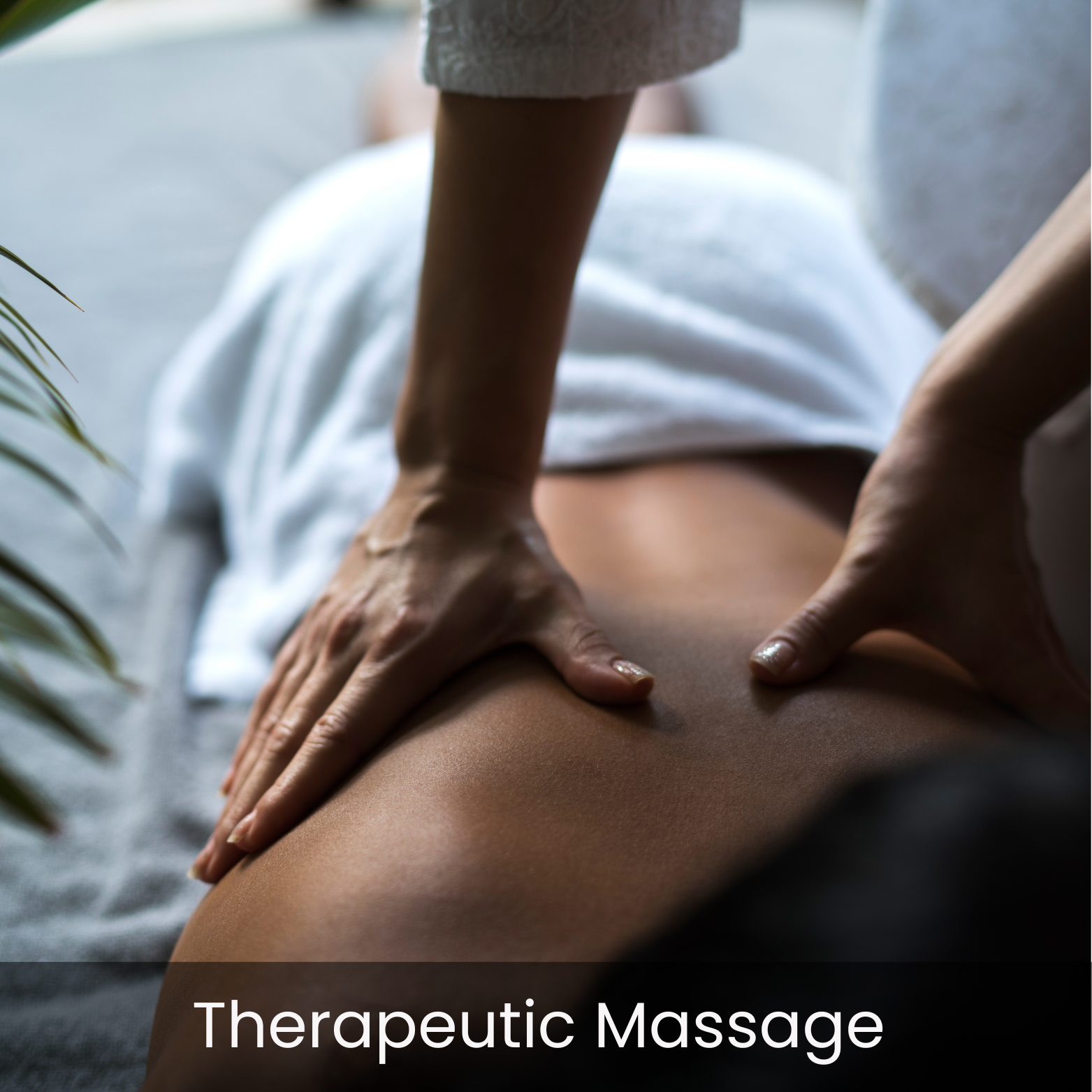 Close-up of a person receiving a therapeutic massage, lying face down with hands placed on their back, in a calm and relaxed setting.
