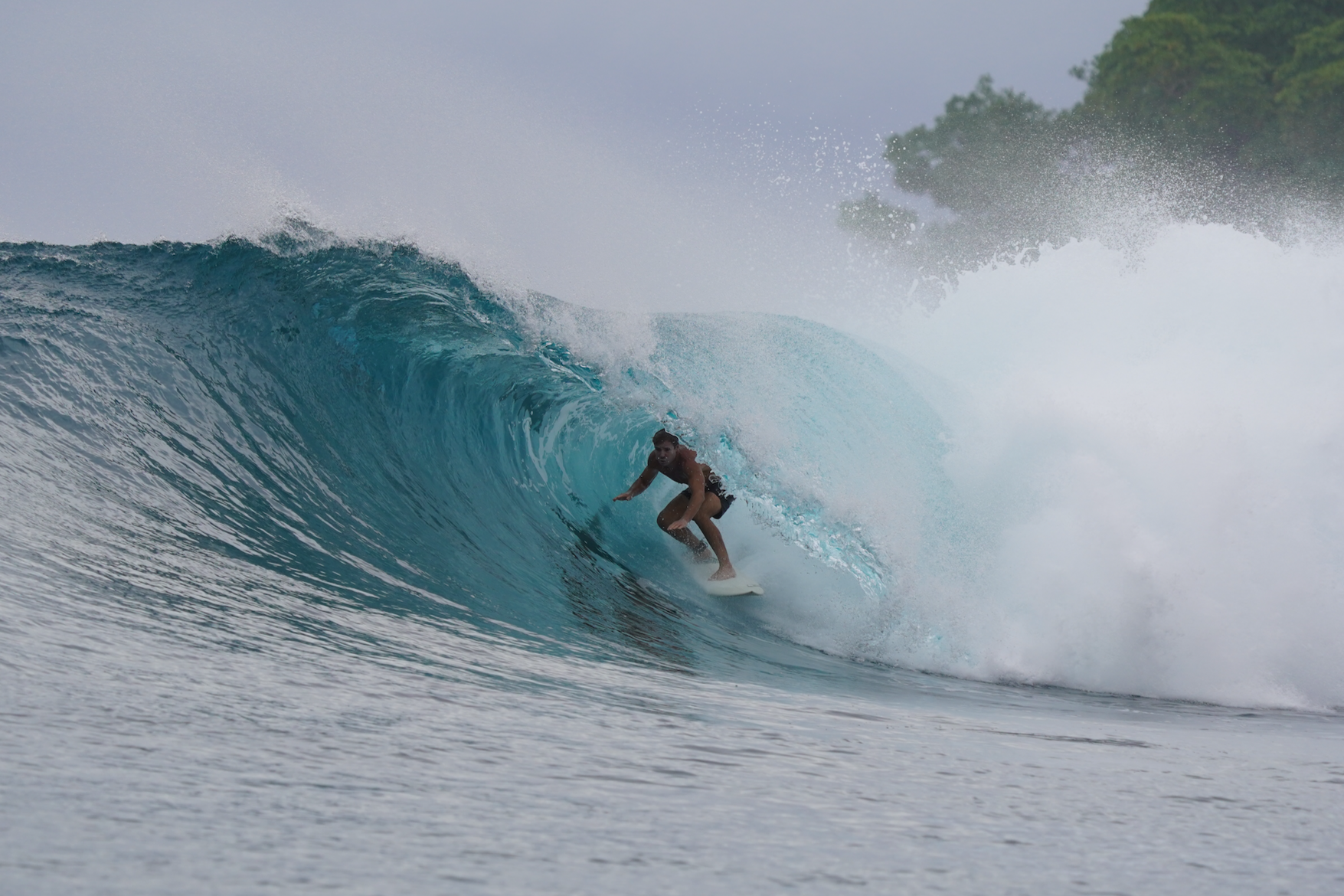 School of barrels Mentawai surf trip onboard experienced surfer riding tube in mentawai