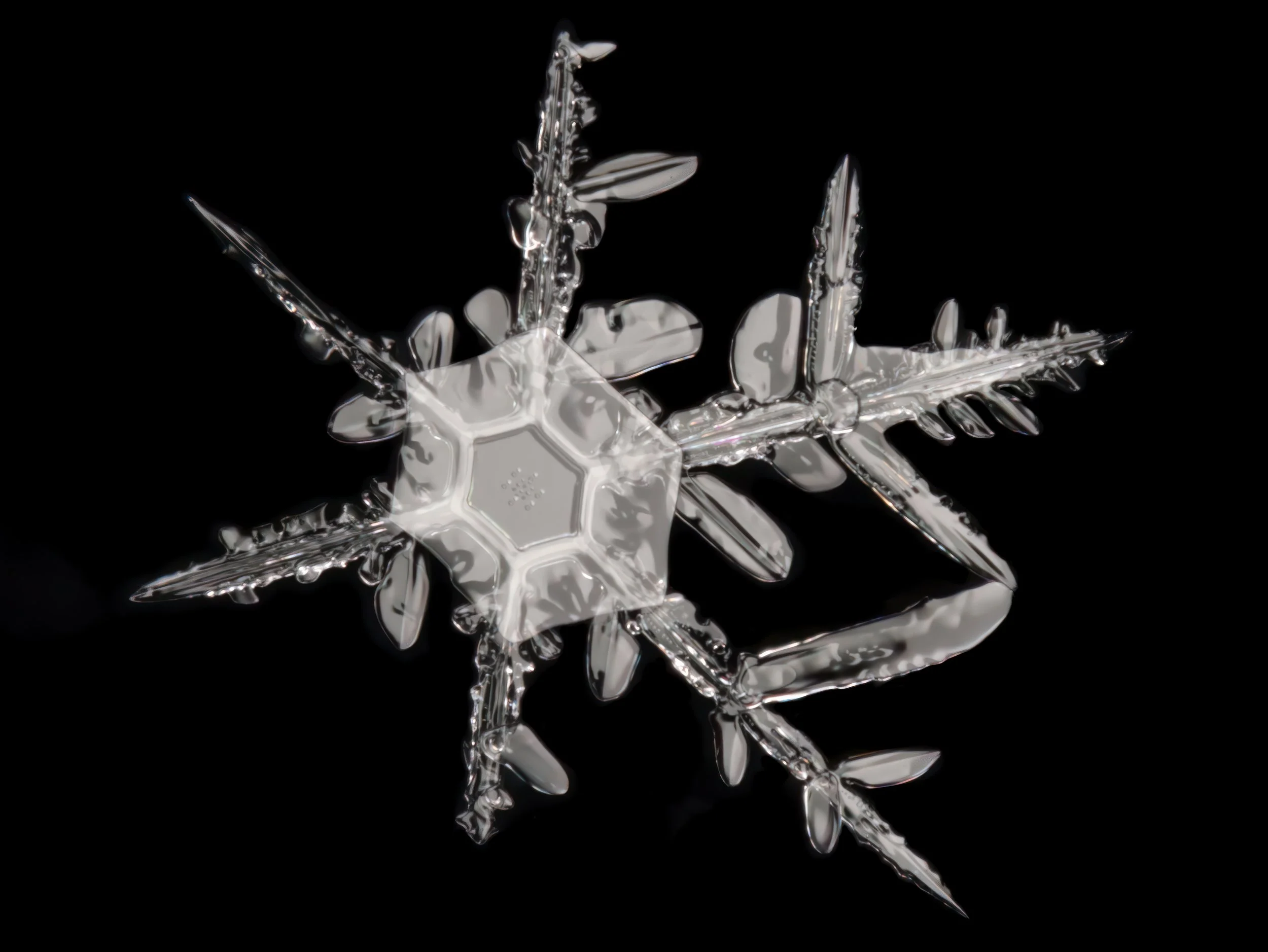 Macro photograph of an irregular shaped snowflake.