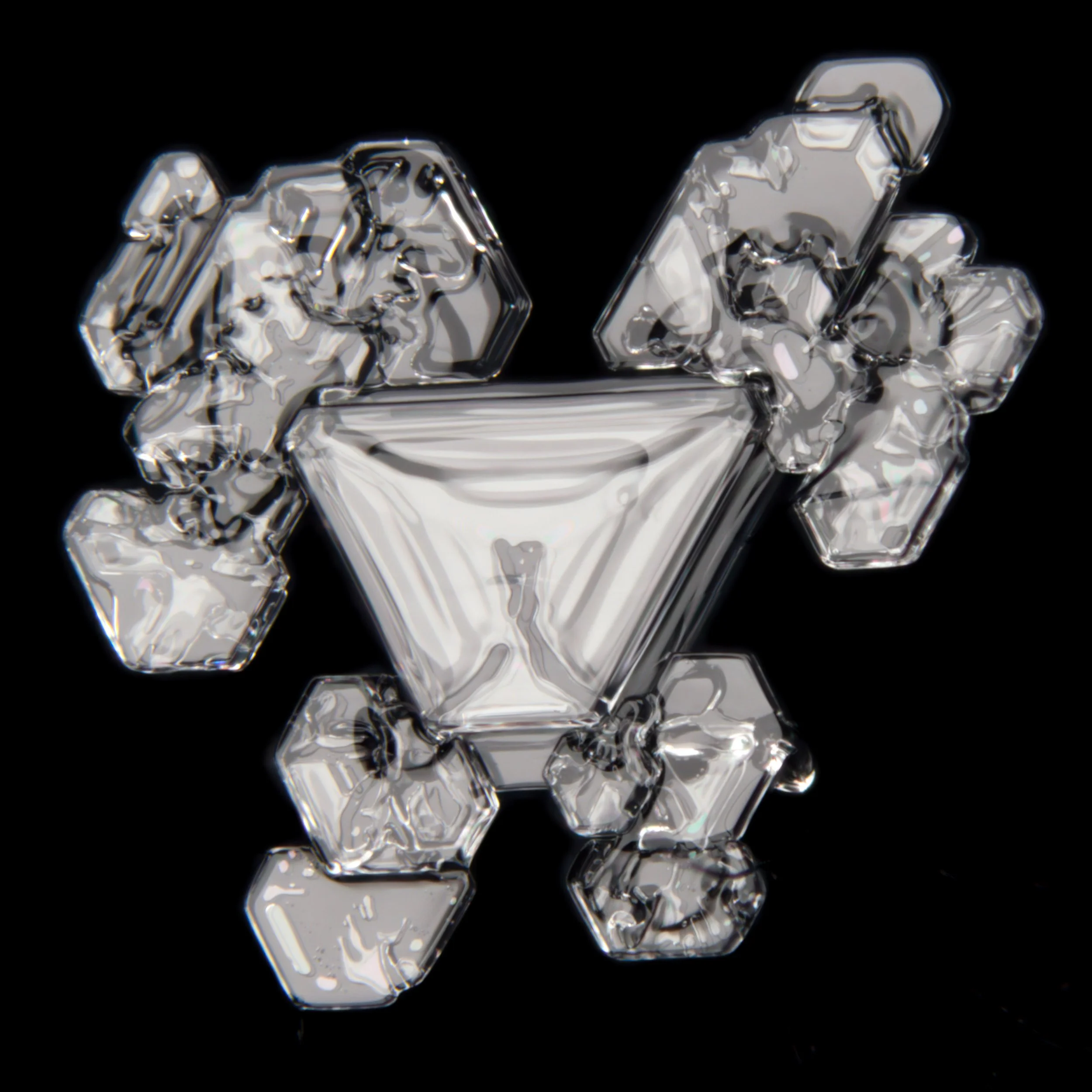 A macro photograph of a very special shaped, irregular snow crystal with colours from thin film interference.