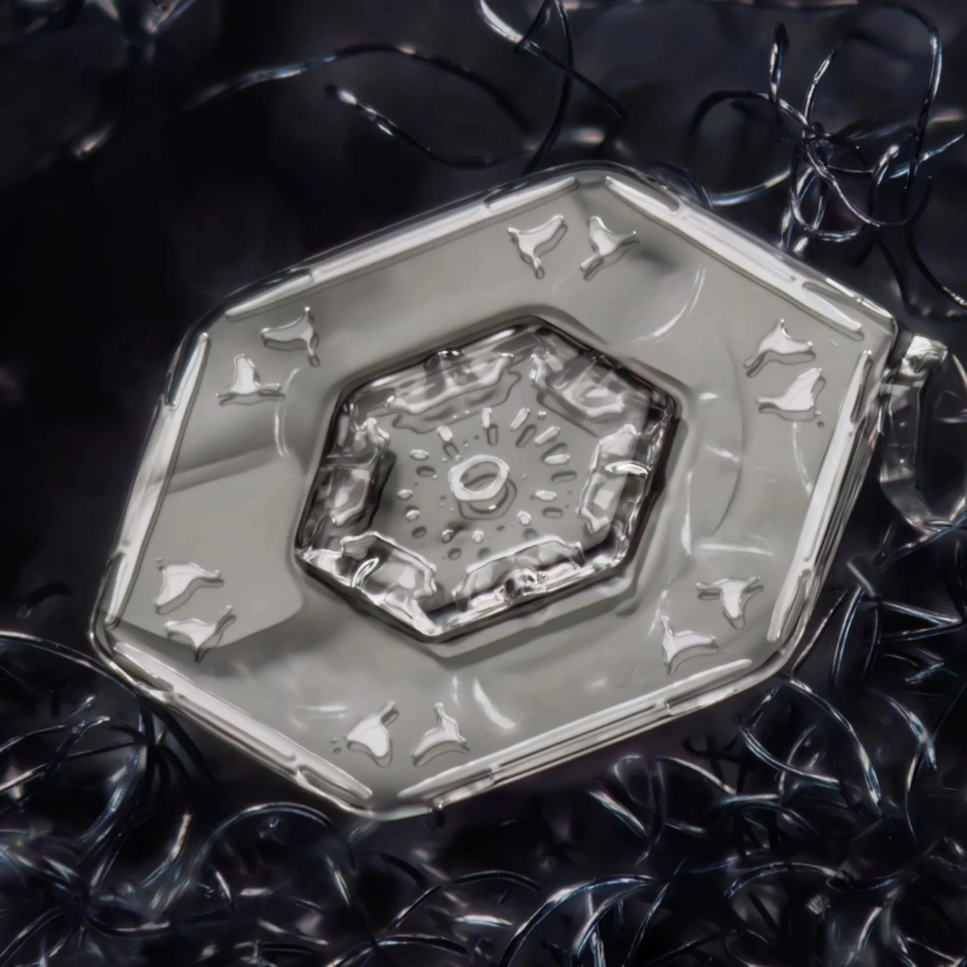 Macro photograph of a transparent plate snow crystal with a hexagonal design, surrounded by smaller scattered pieces of string.