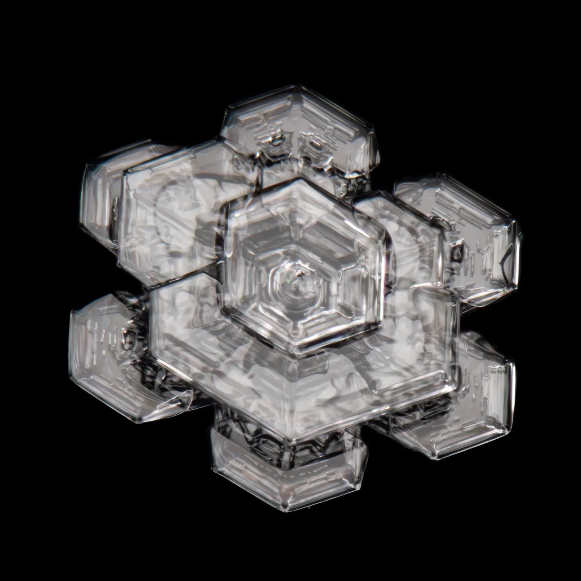 Macro photograph of a glassy triple plate snowflake.