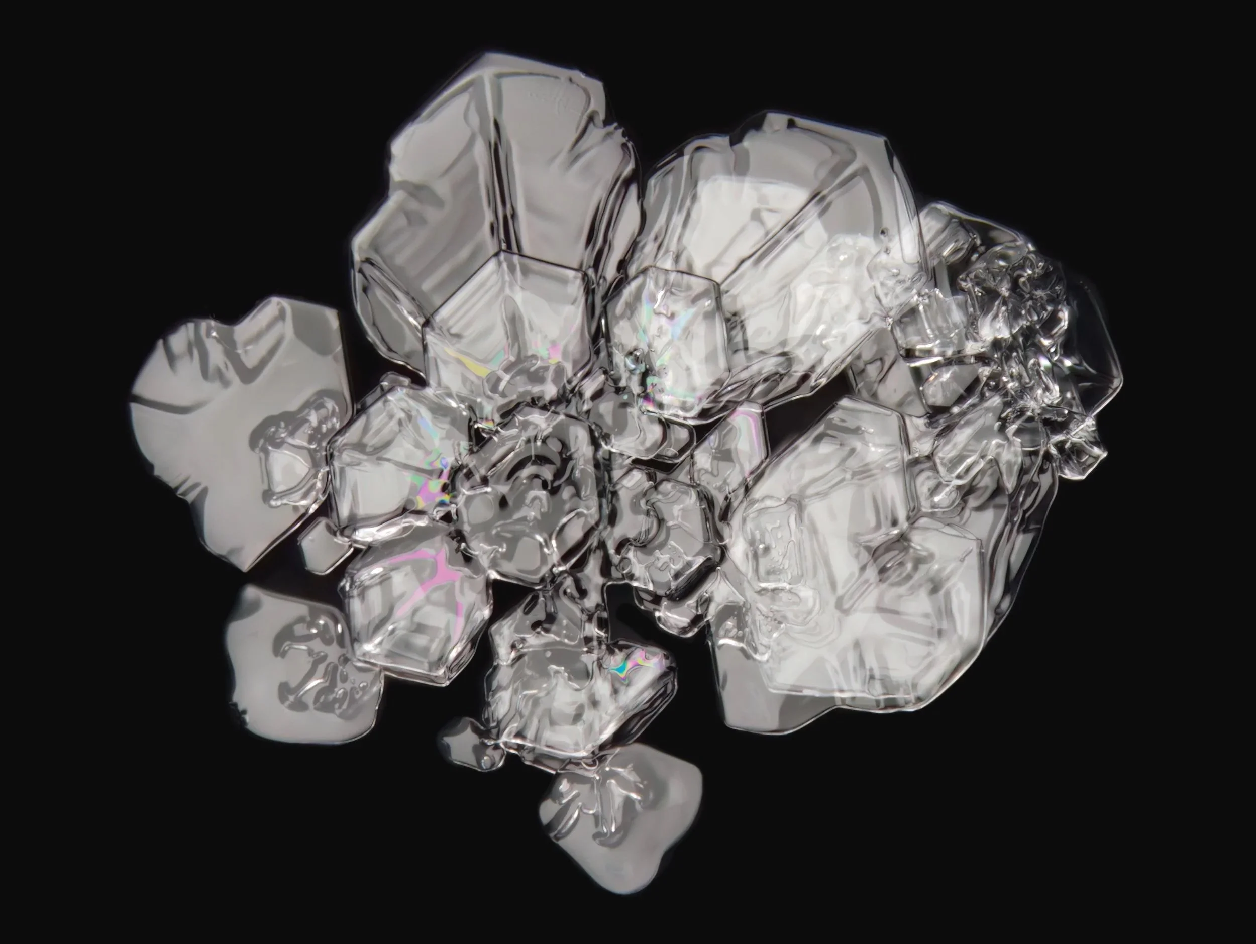 Macro photograph of a clear irregular shaped snowflake with colorful patterns.