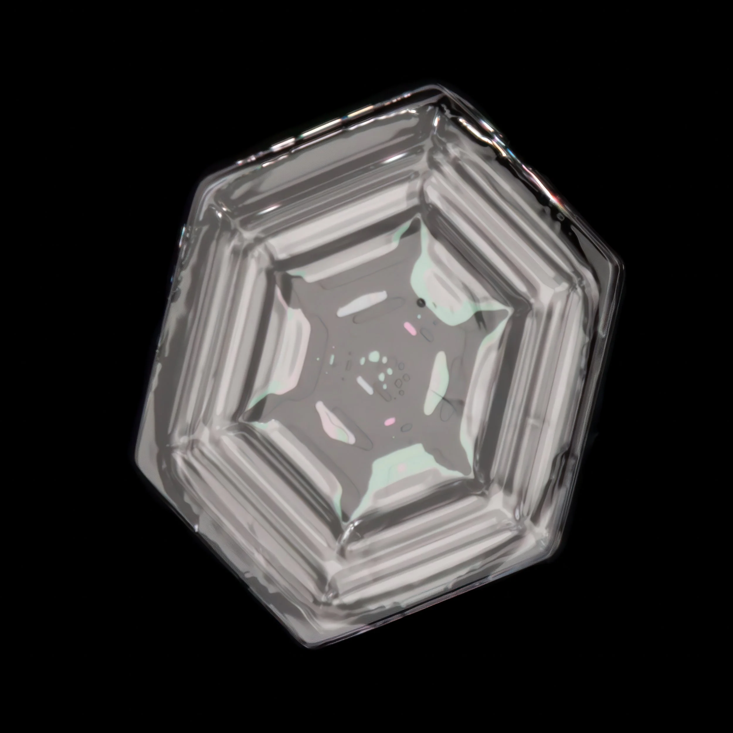 Macro photograph of a clear simple plate snowflake with a thin film color refraction in the center part.