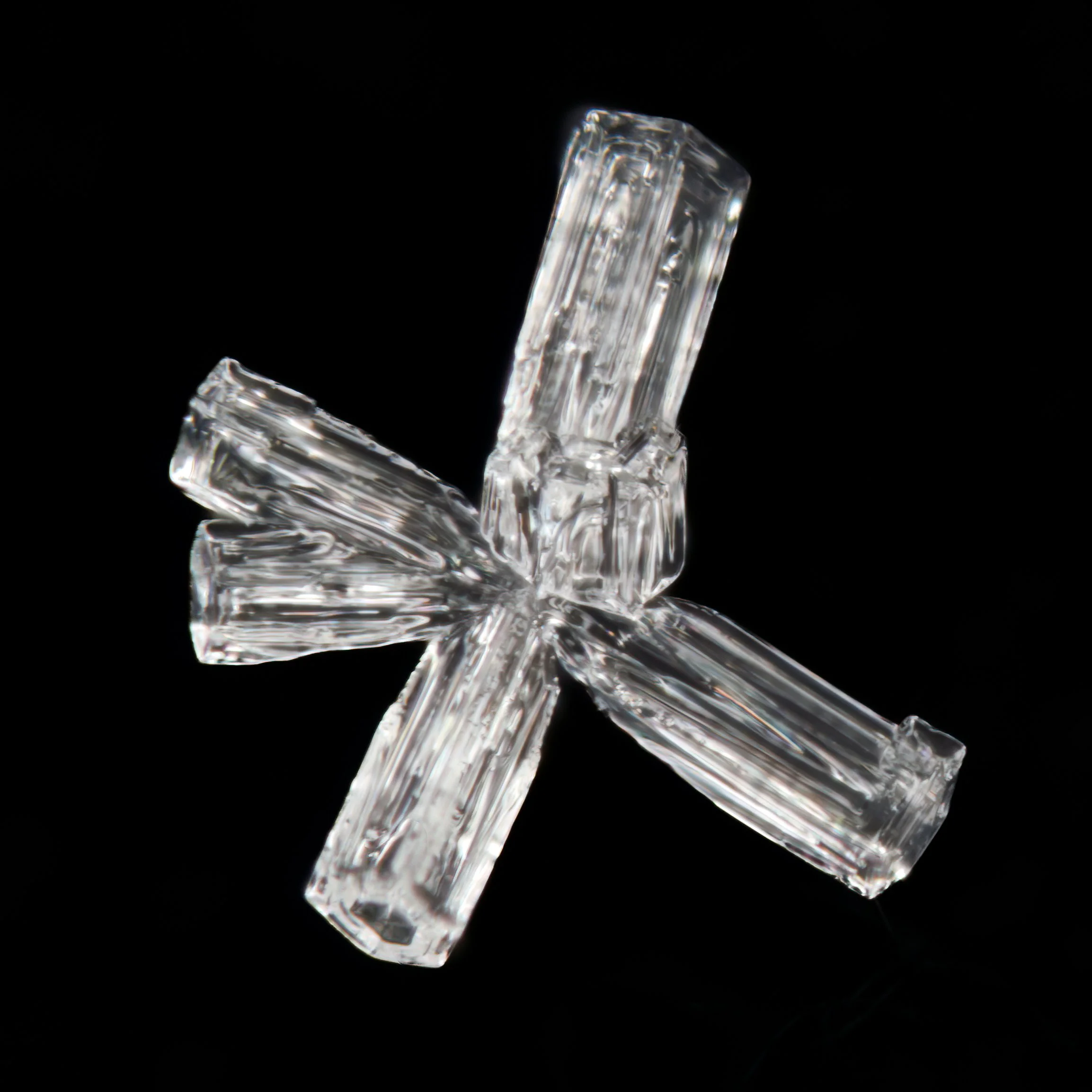 Macro photograph of an irregular snow crystal.