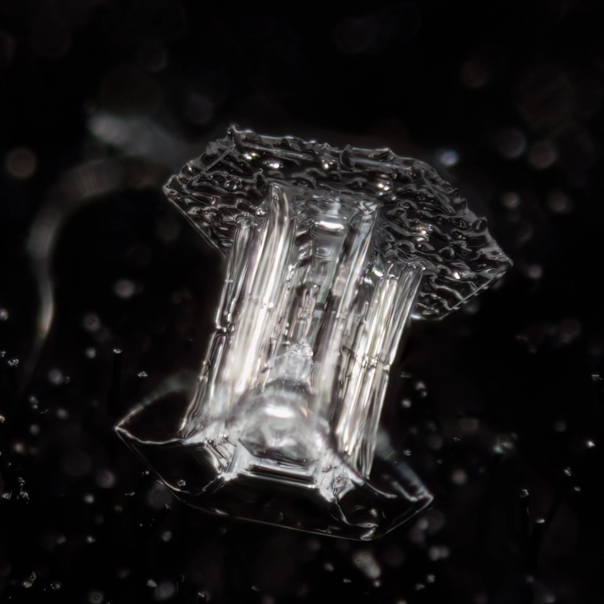 Macro photograph of a hollow column snow crystal.