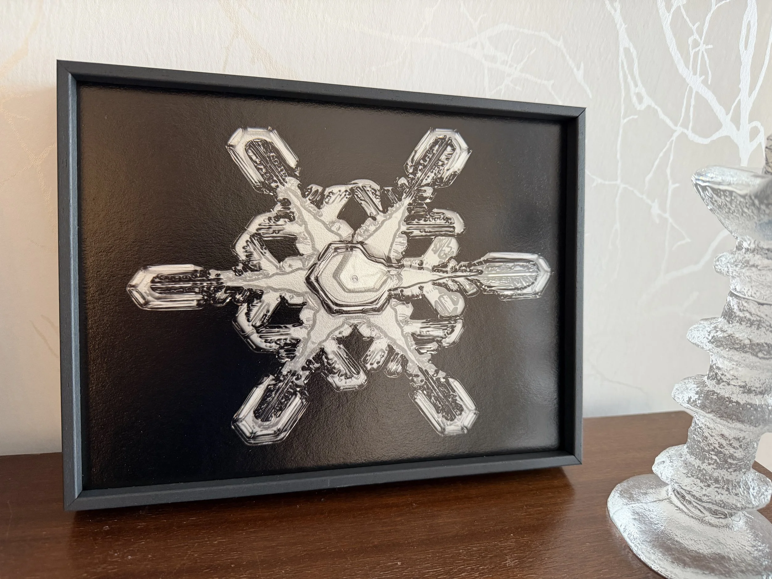 Fine art snowflake photograph showing a split star shaped snow crystal.