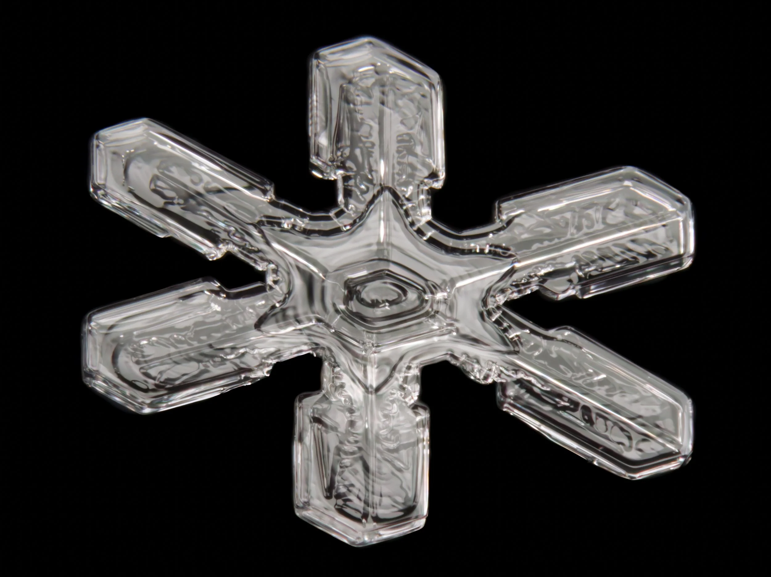 Macro photograph of a symmetrical  stellar dendrite snowflake with thick branches.