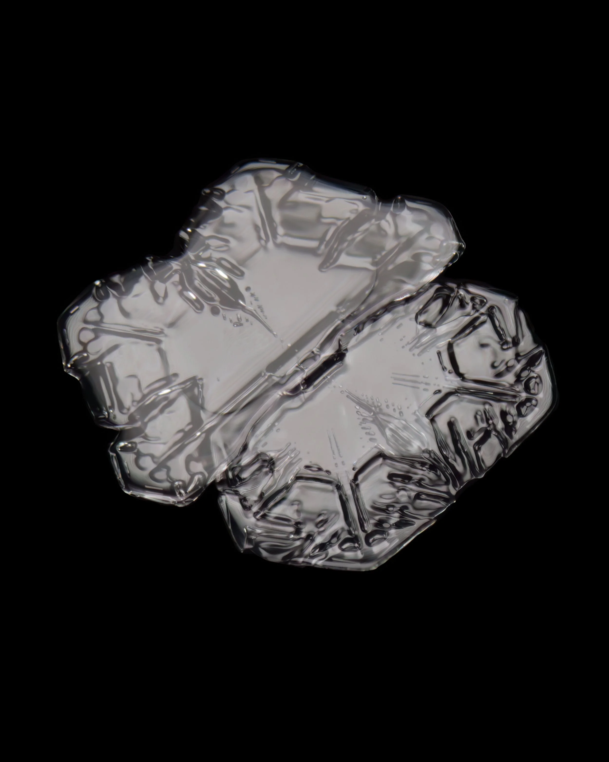 Macro photograph of an irregular shaped snow crystal.