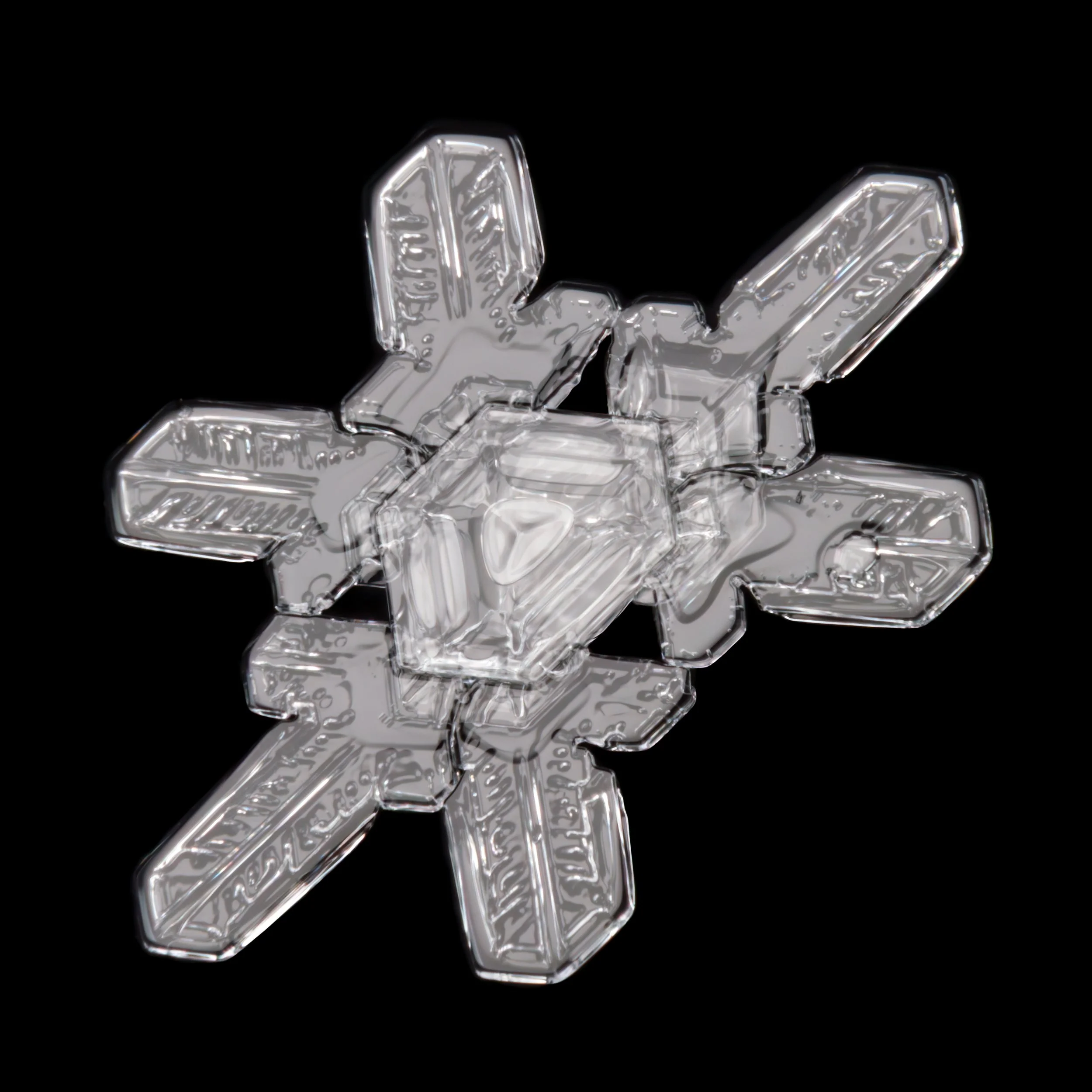 Macro photograph of a snow crystal with symmetrical branches and hexagonal center part.