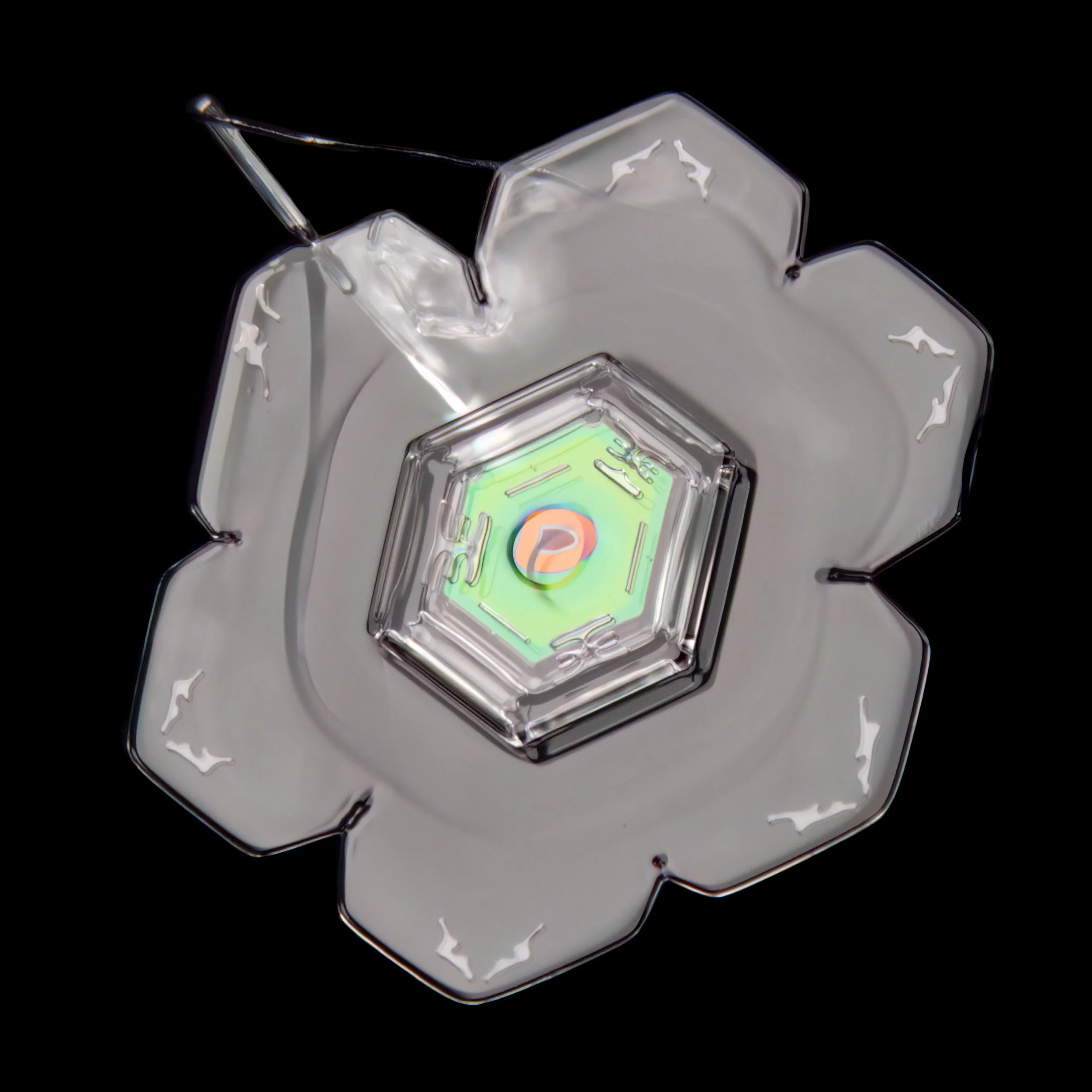Macro photograph of a sectored plate snowflake with colorful patterns in the center part.