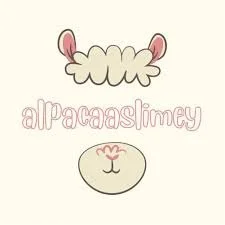 A cute cartoon illustration of a lamb with pink ears and a pink nose. The lamb's face is below the word 'alpacaaslimey' written in pink, playful letters.