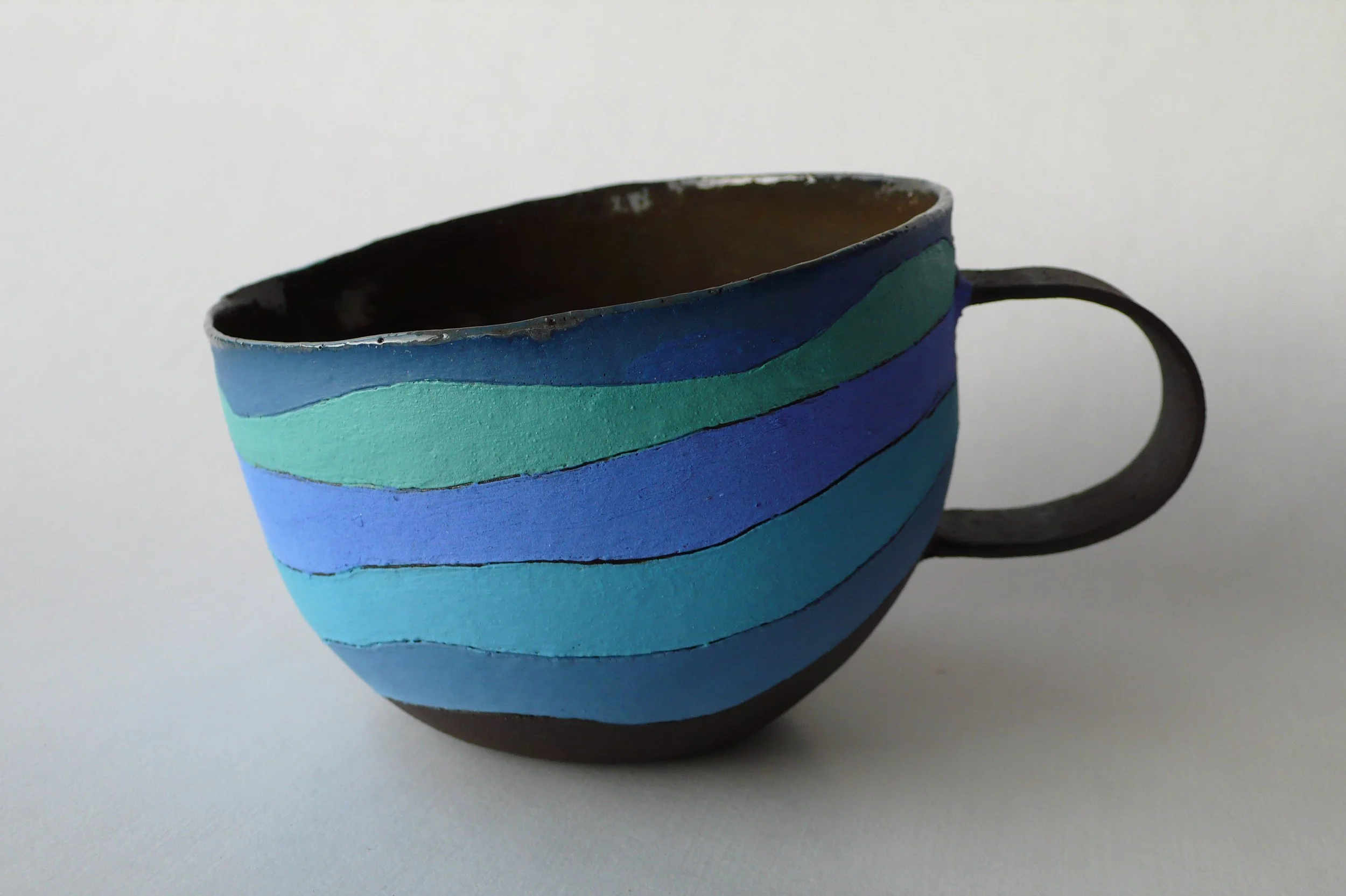 Contemporary hand-built black stoneware cup with blue rhythmic inlaid slips from the Celestial Rhythm series by Marisa Iona.