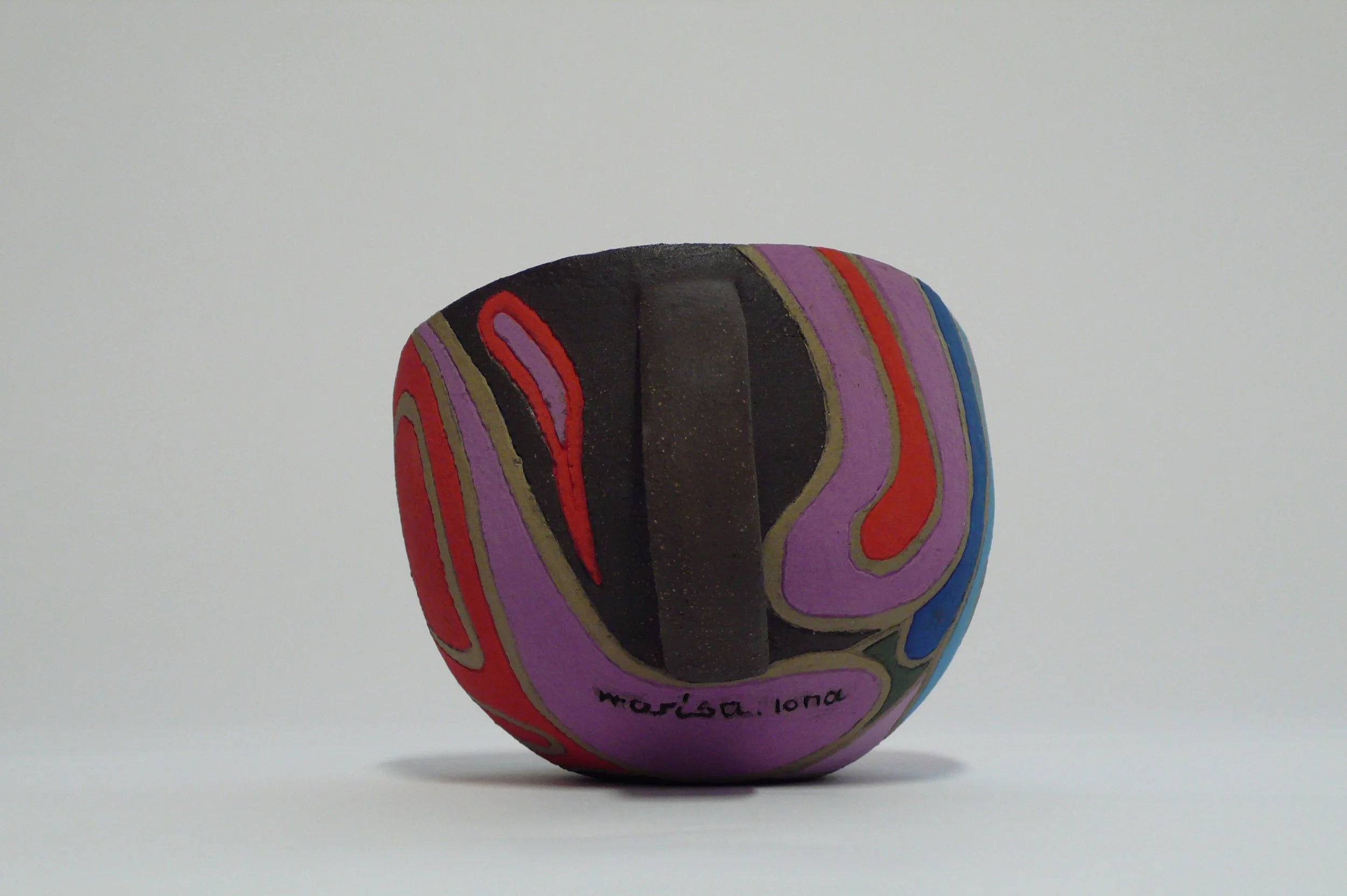 Hand-built black stoneware cup with multi-colored rhythmic inlaid slips by Marisa Iona.