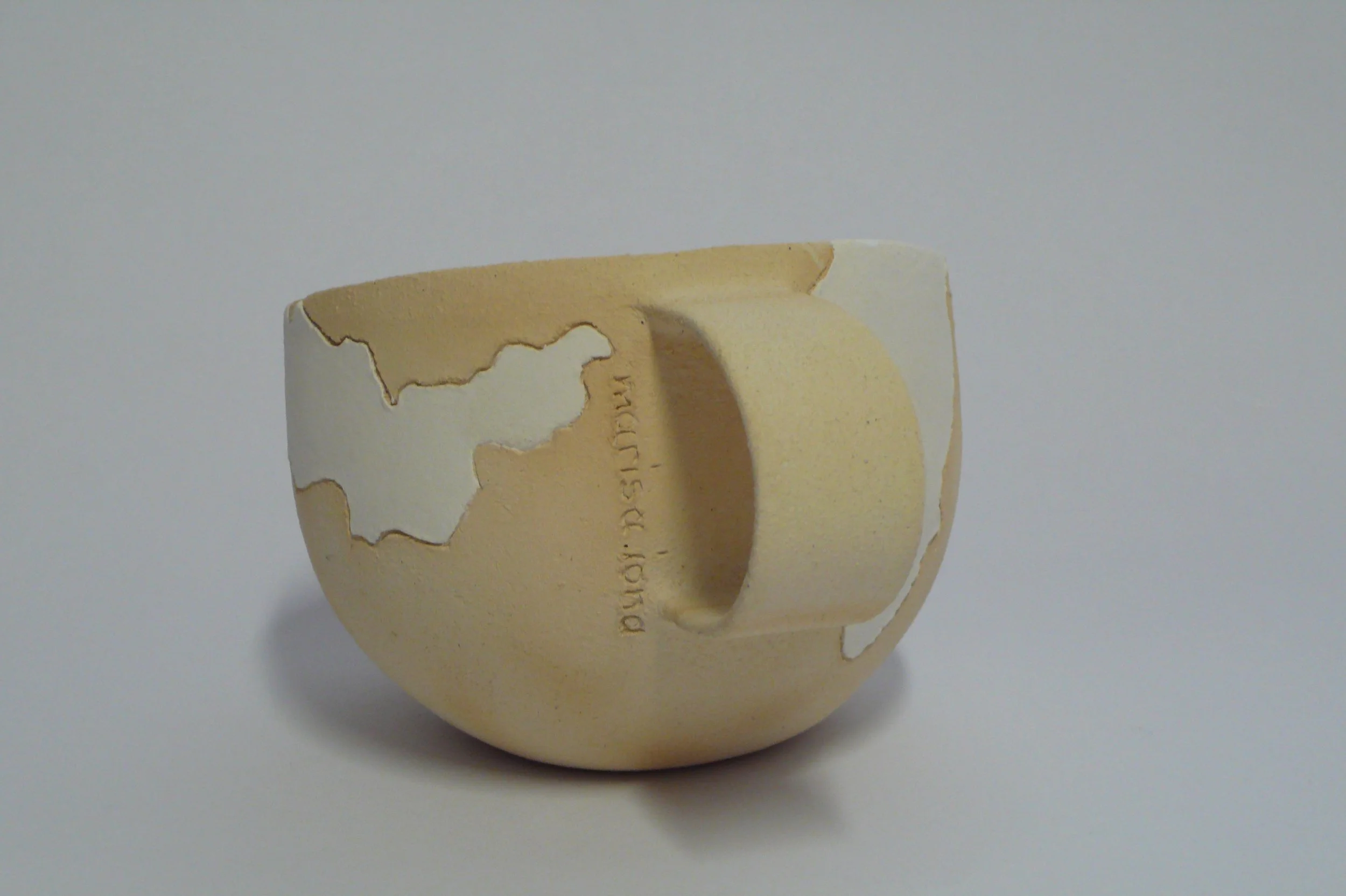 Minimalist hand-built ceramic cup with hand-carved white geometric inlay on raw stoneware by Marisa Iona.