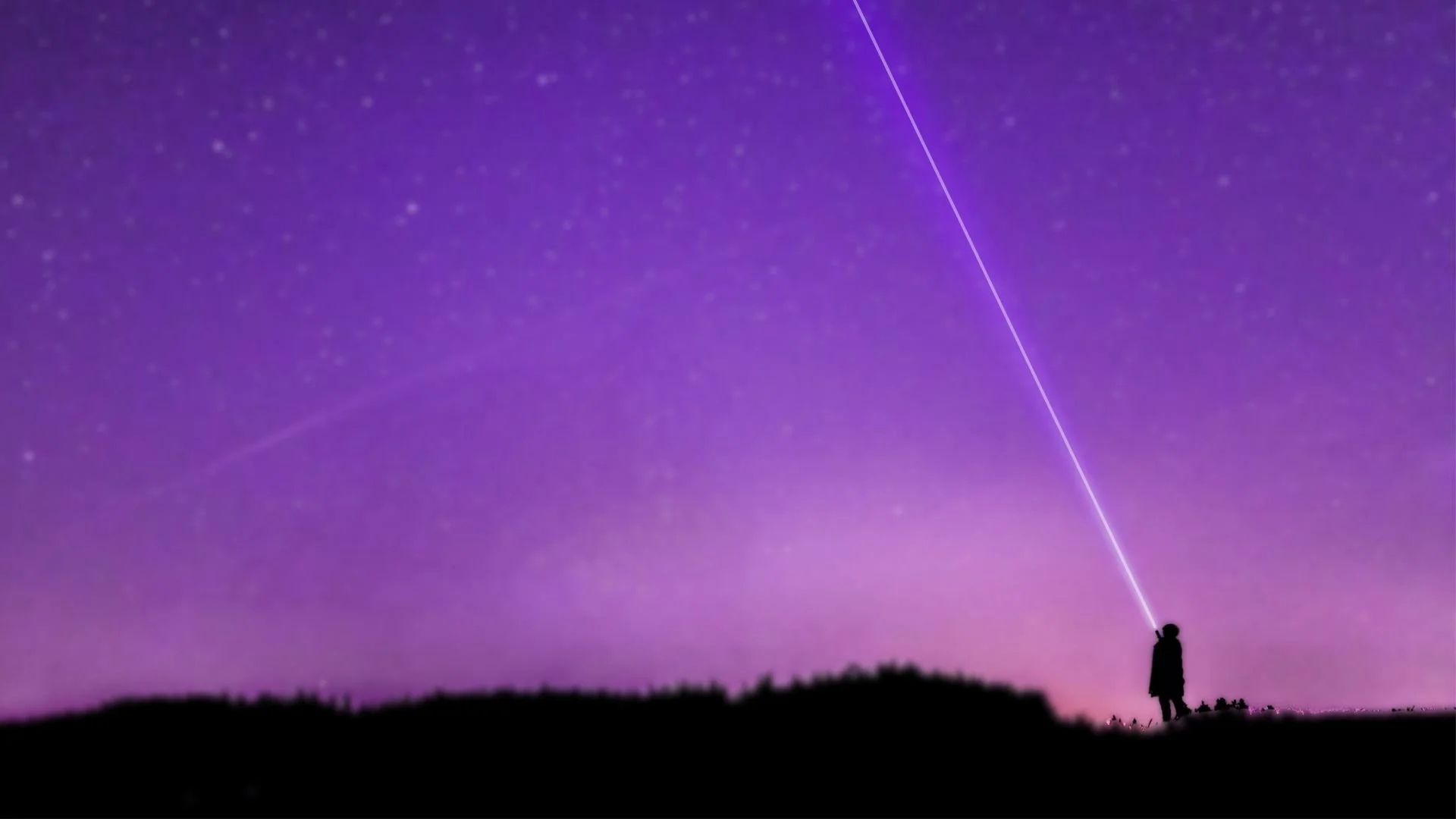 Silhouette of a person standing on a dark hilltop at night, aiming a flashlight towards the starry sky with streaks of light and purple hues.
