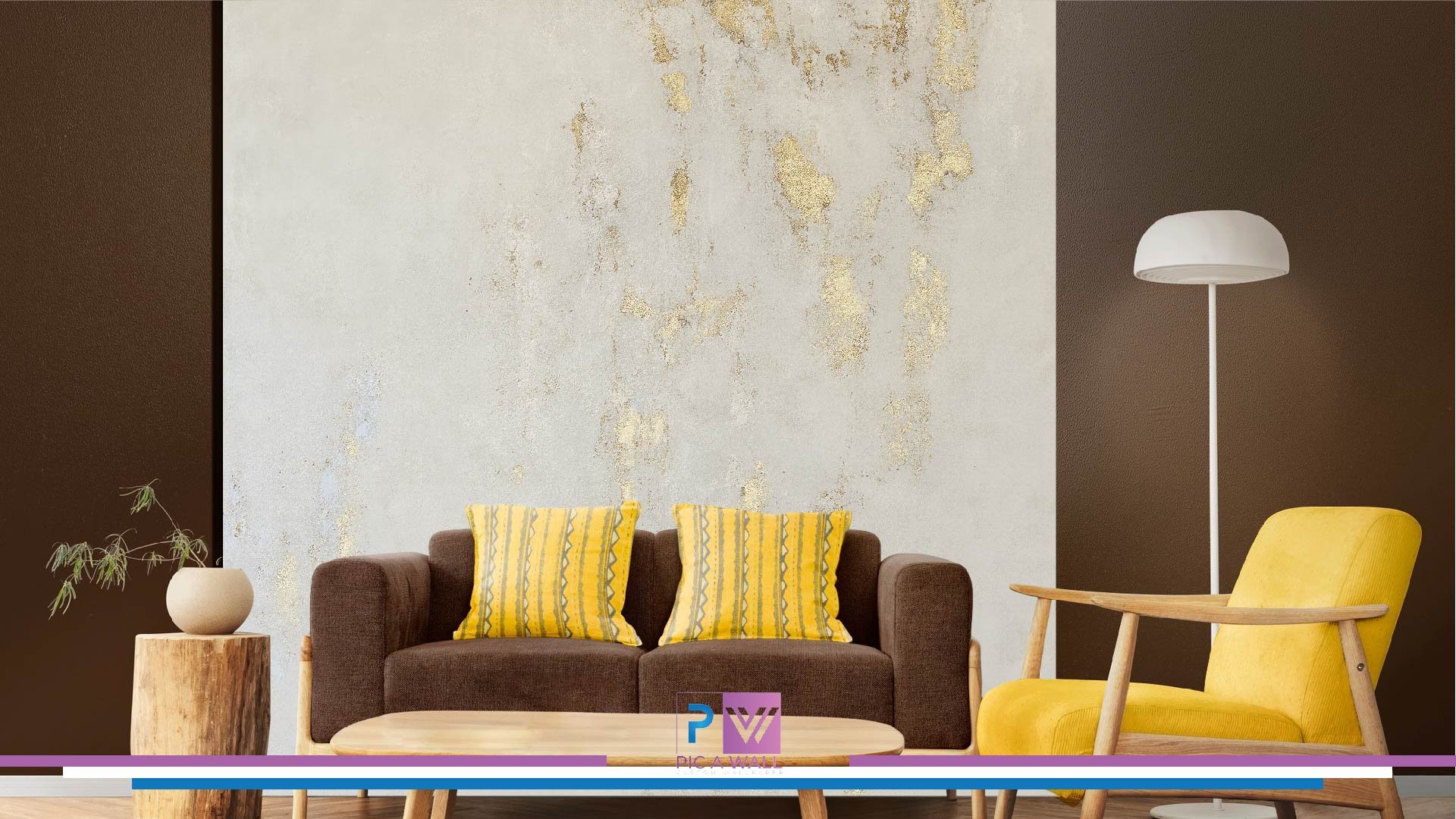 Living room with a brown sofa and yellow pillows, a yellow armchair, a tall white floor lamp, a small wooden side table with a potted plant, and a textured beige and dark brown wall.