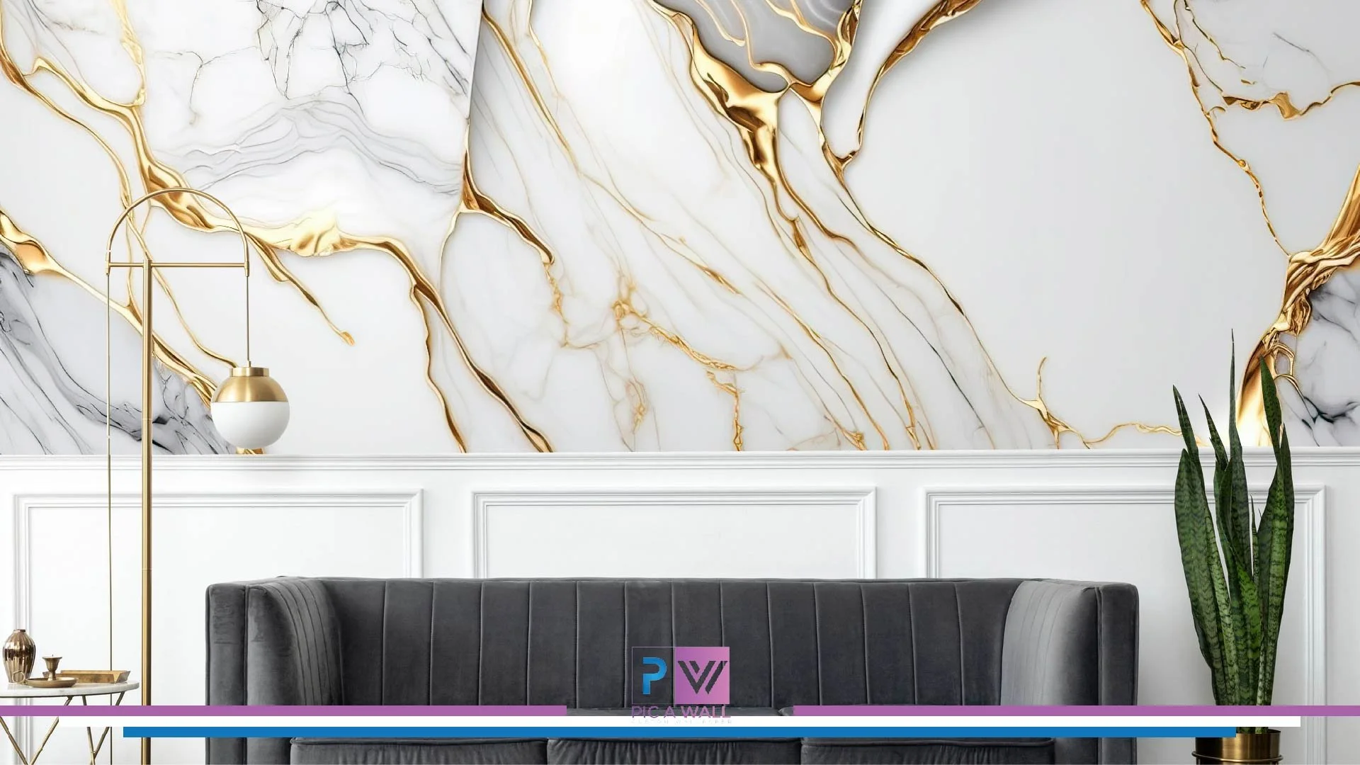 Modern living room with a marble-style wall featuring gold veins, white paneling, a black velvet sofa, a tall snake plant in a gold pot, and a gold and white floor lamp.