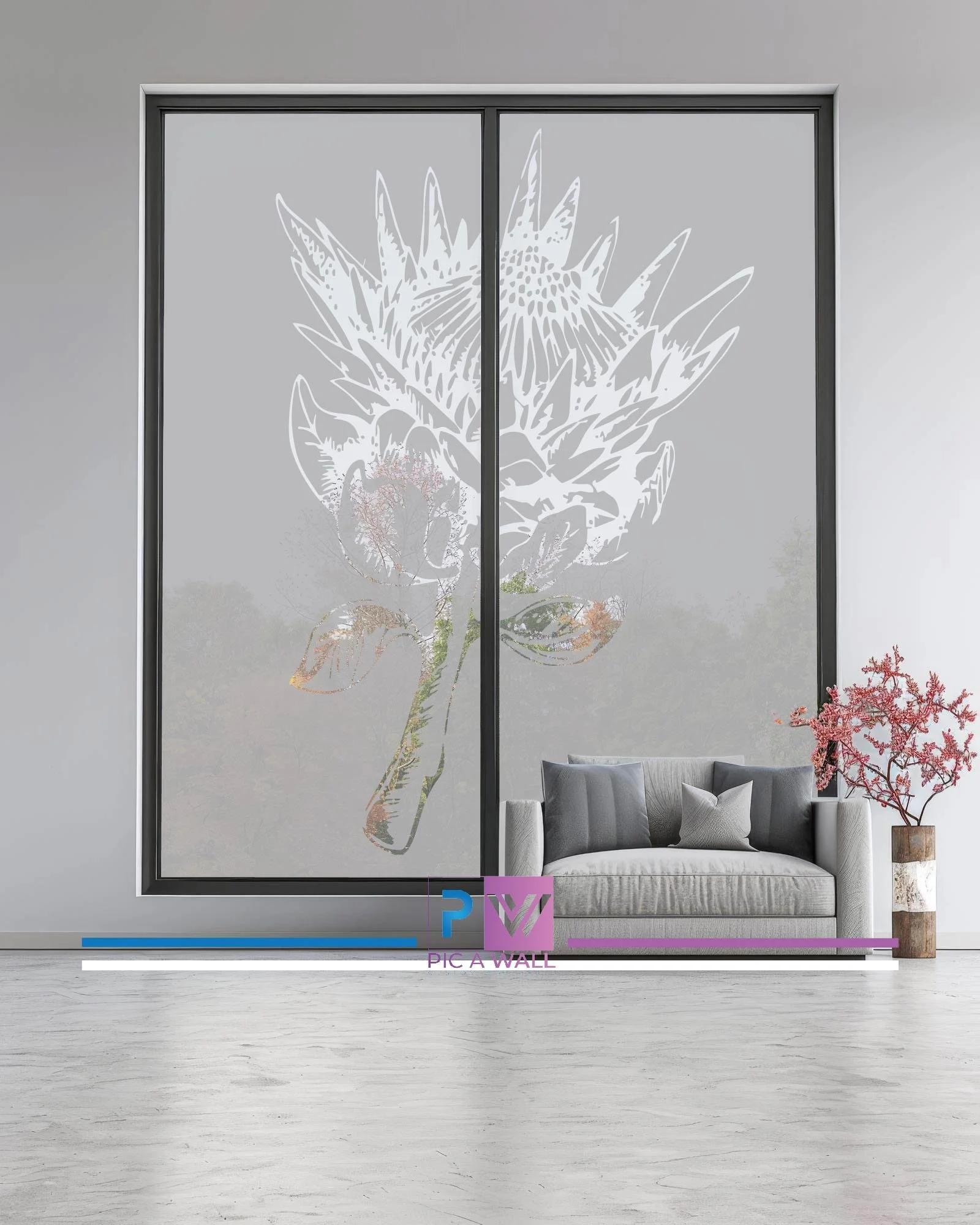 Modern living room with large frosted glass window featuring a floral design, a gray sofa with pillows, and a pink flowering plant in a vase.