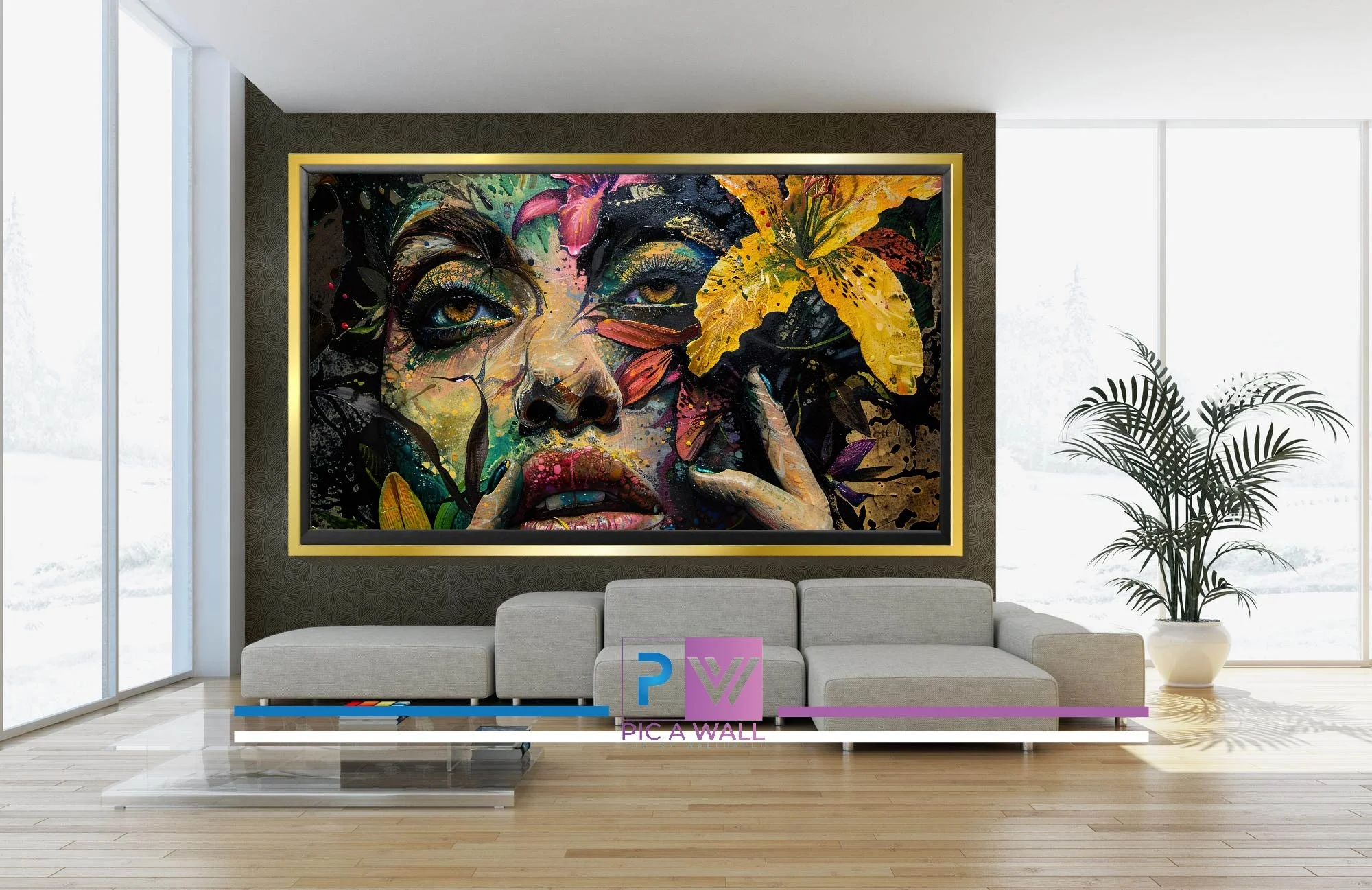 Modern living room with a large colorful abstract painting of a woman's face with flowers on the wall behind a gray sectional sofa. There is a glass coffee table and a potted plant near the window.