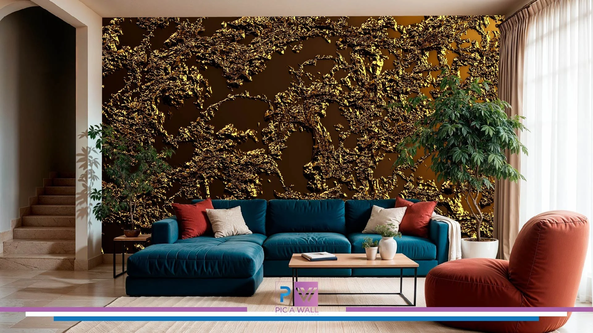 Living room with a dark gold textured wall behind a blue sectional sofa and a red lounge chair, two potted trees, a light wood coffee table with small plants and books, and curtains on large window to the right.