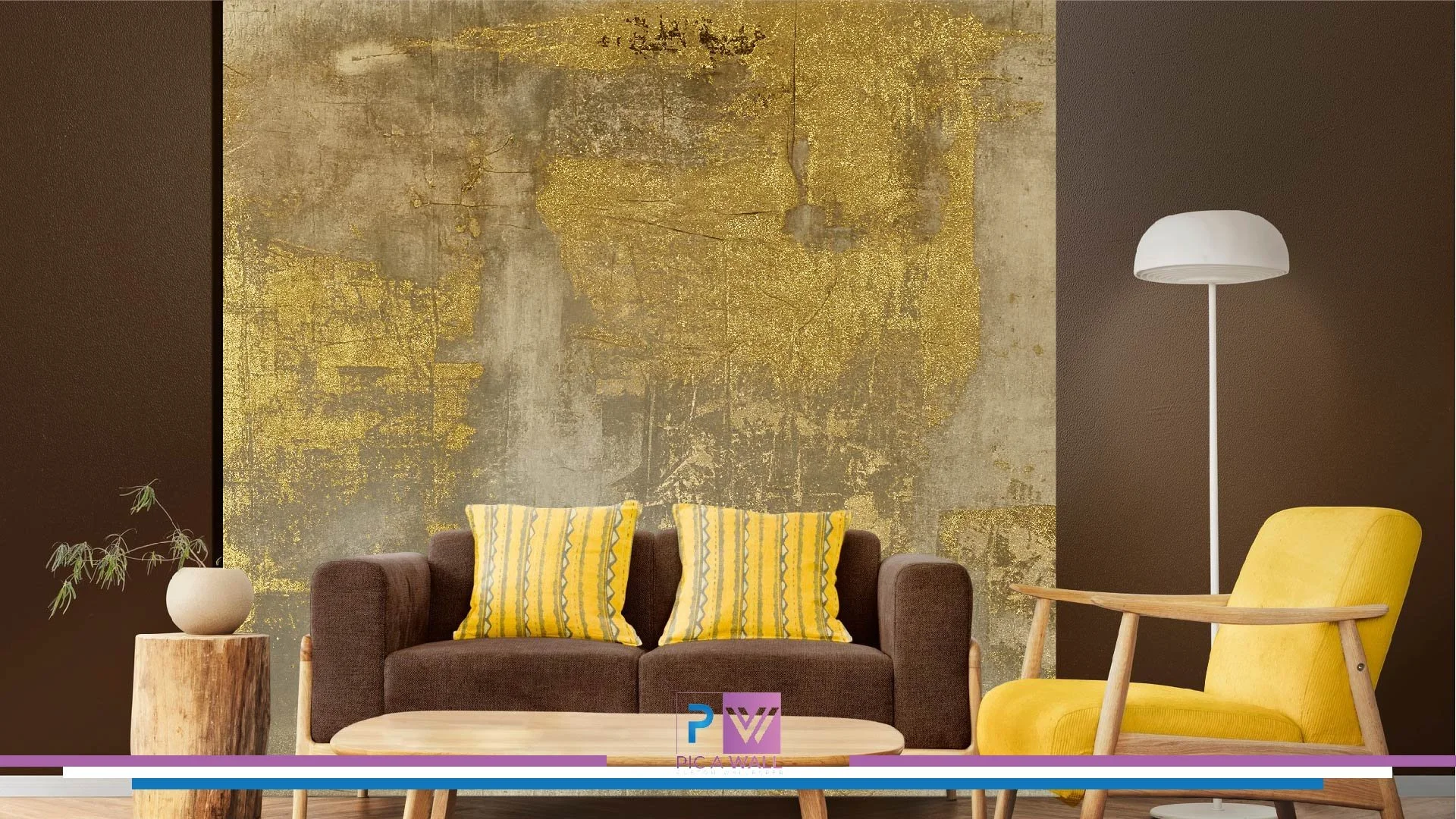 Living room with a brown sofa, yellow throw pillows, a yellow armchair, a white floor lamp, and a wooden side table with a plant on it, against a textured gold and gray wall.