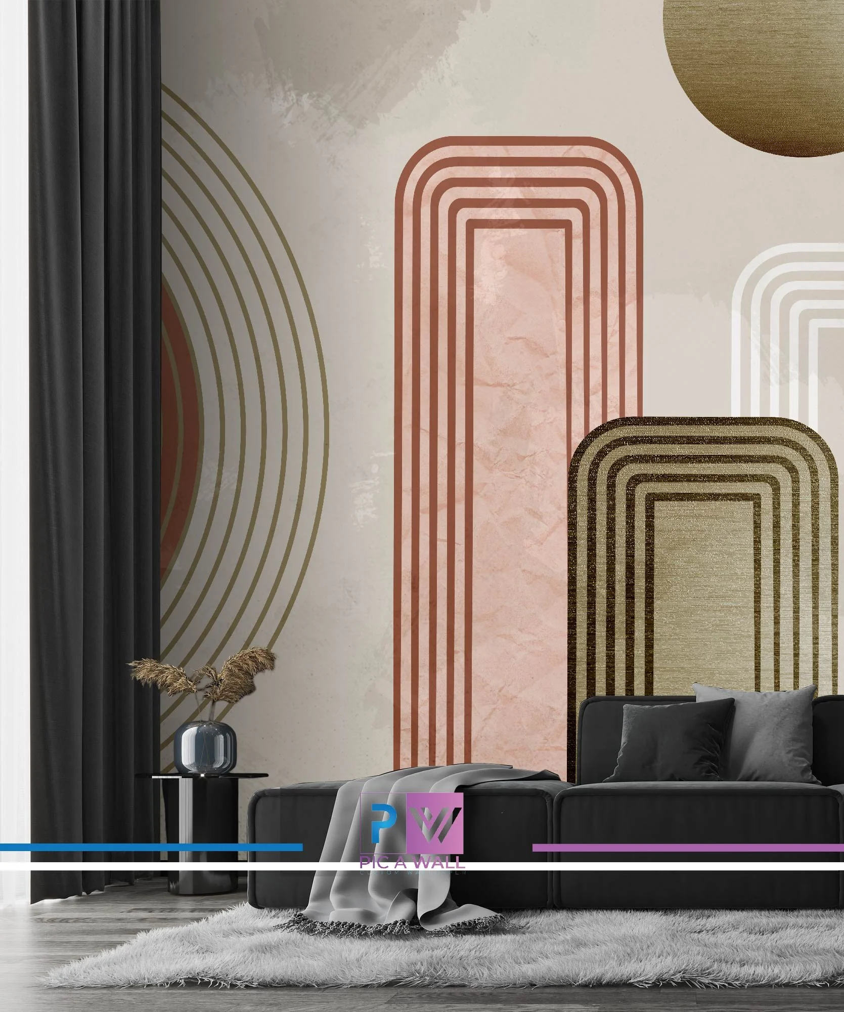 Modern living room with a black sofa, a plush rug, and a wall decorated with abstract geometric patterns in earth tones and metallic colors. A black side table holds a vase with dried pampas grass, and black curtains hang to the left.