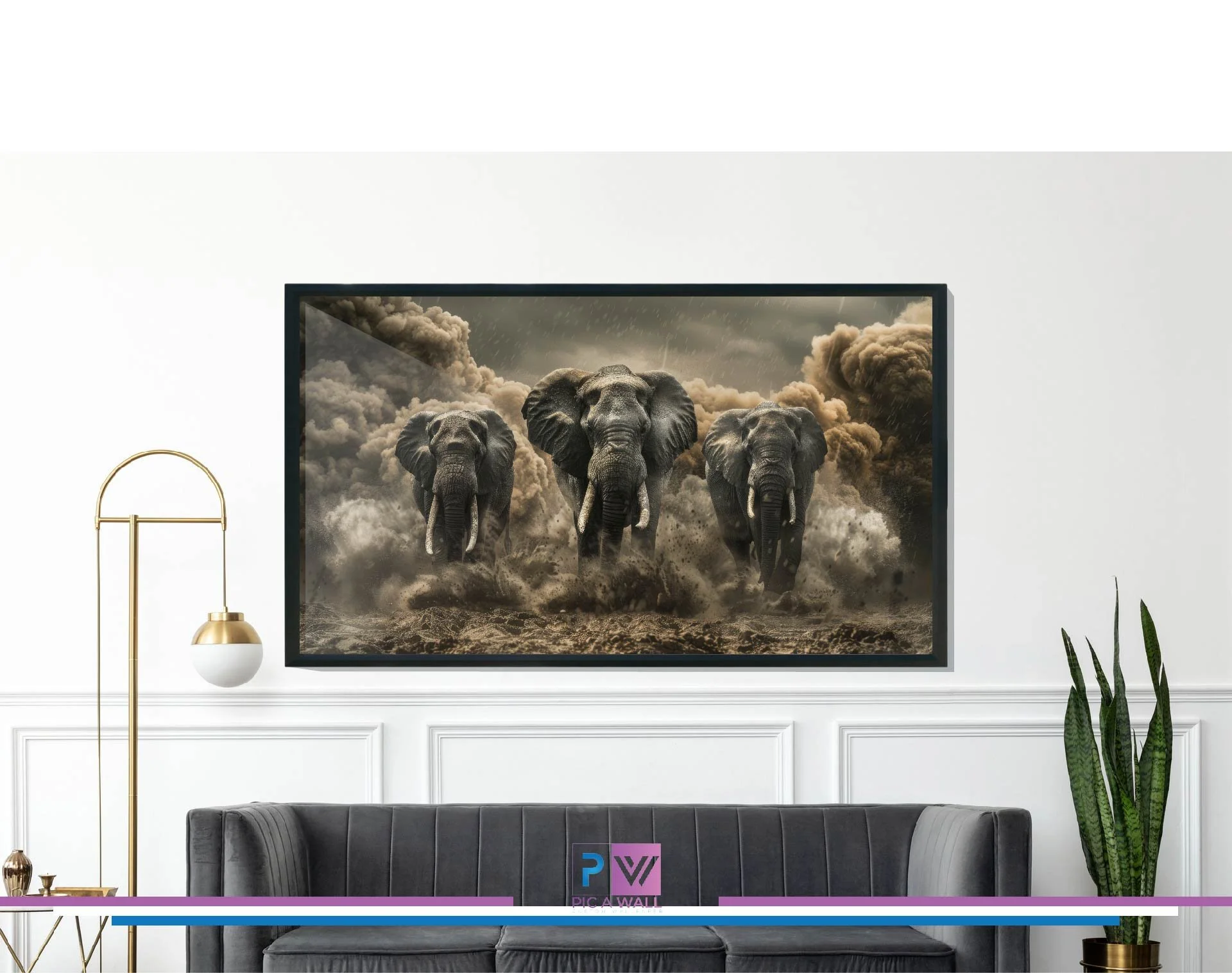 A digital artwork of three elephants walking through a dusty landscape with dark, stormy clouds in the background, displayed on a wall in a modern living room.