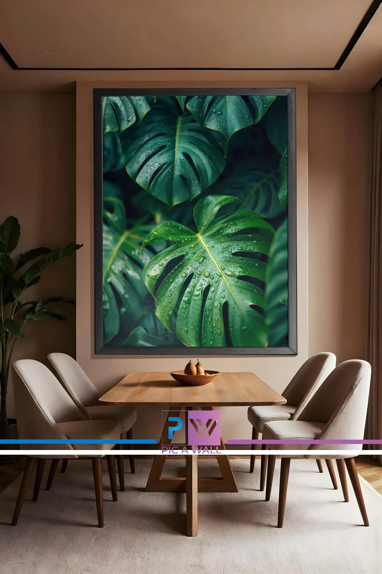 Dining room with a wooden table, six beige chairs, a large wall art of green monstera leaves with water droplets, a small potted plant, and a fruit bowl on the table.