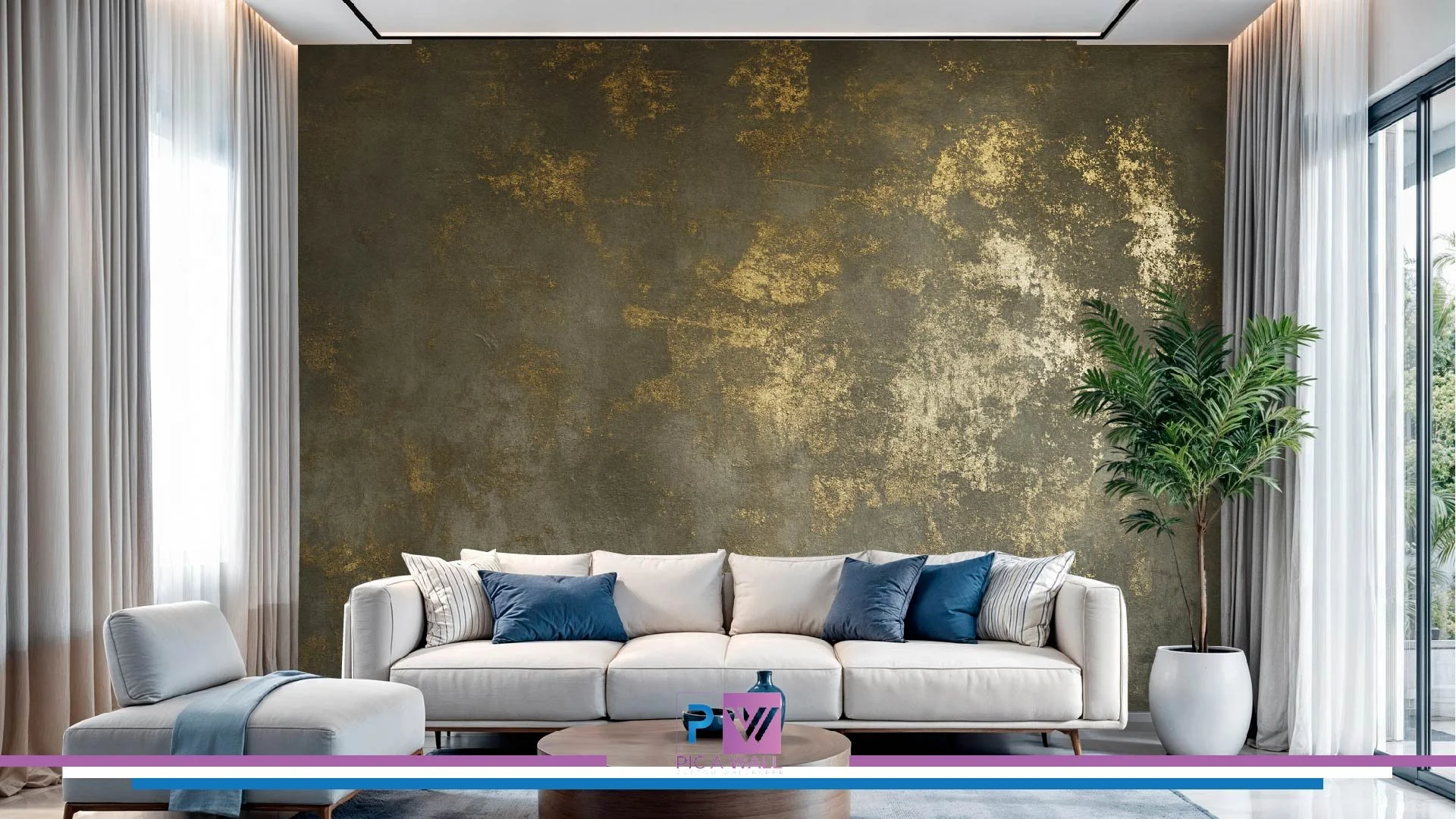 Modern living room with a white sofa, blue and striped pillows, a large potted plant, and sheer white curtains next to sliding glass doors, with a textured dark gold accent wall.