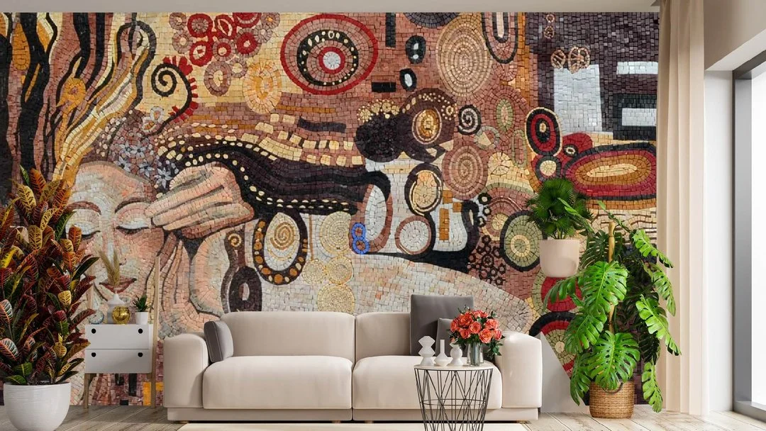 Interior living room featuring a large mosaic wall art, a white sofa with gray and black cushions, a small round side table with pink roses, and several green plants near a window.