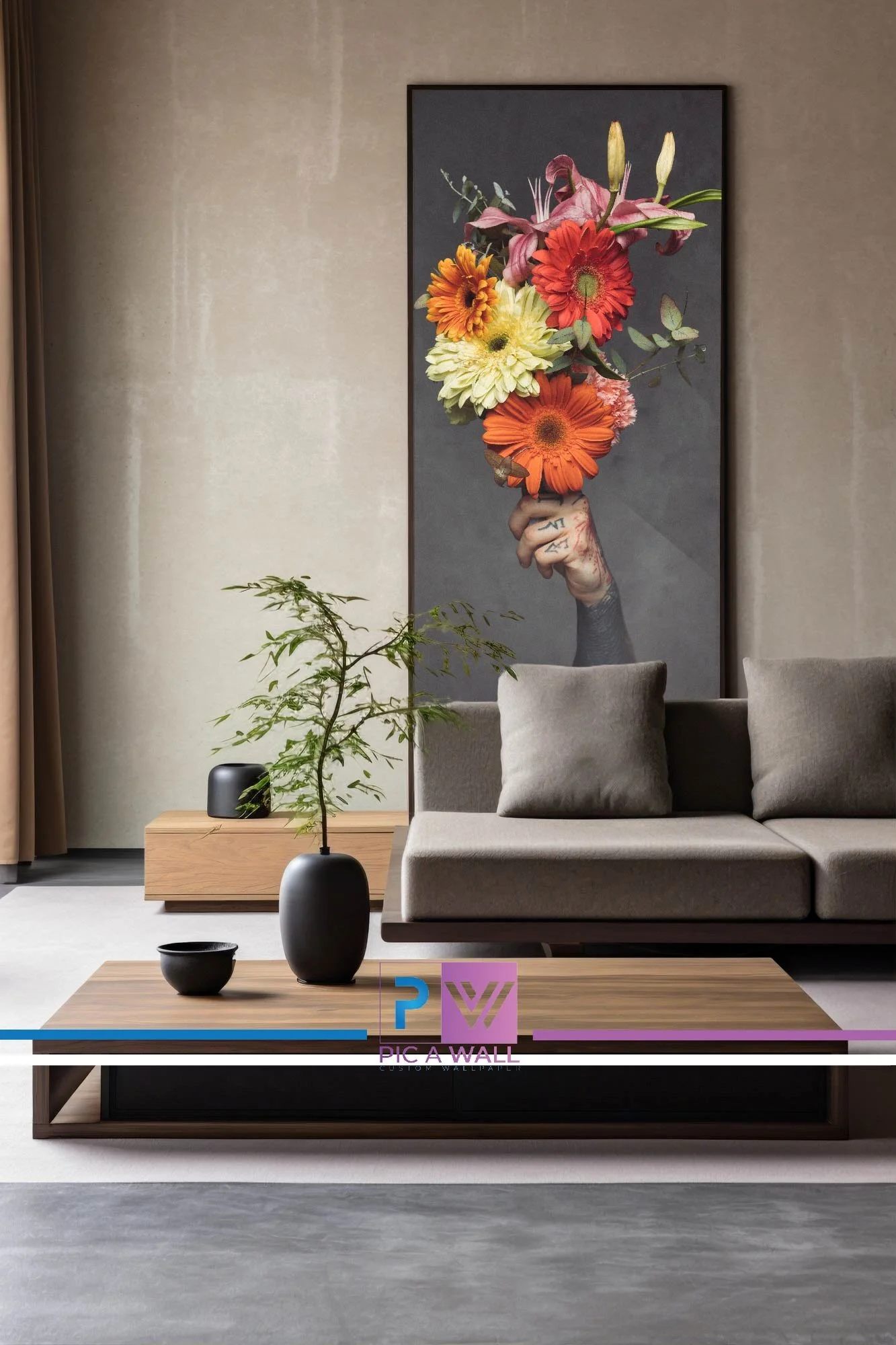Modern living room with a large framed artwork of a hand holding a bouquet of colorful flowers on the wall, a beige sofa with matching pillows, a wooden coffee table with black and green vases, and a potted plant. 