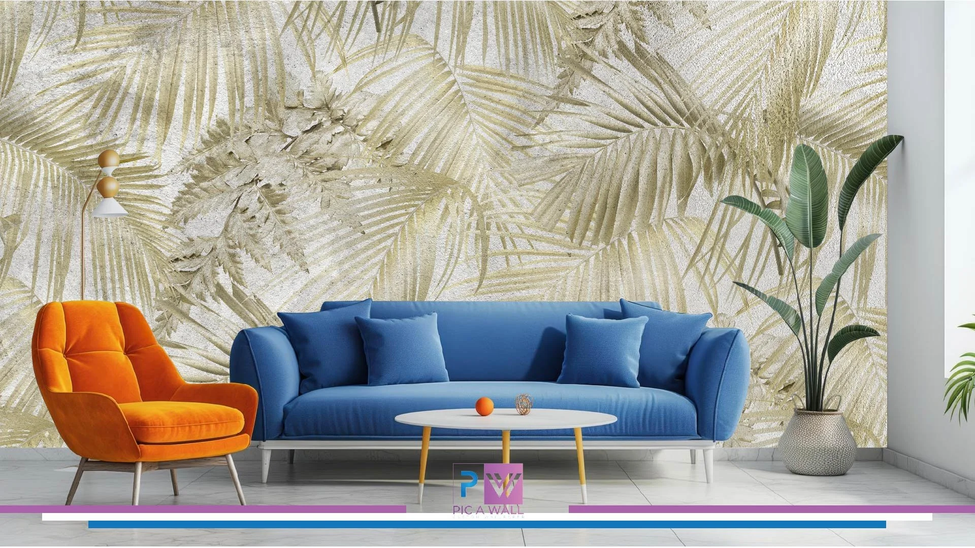 Living room with a sandy beige and green tropical palm leaf patterned wallpaper, a bright orange armchair, a blue sofa with matching pillows, a white coffee table with small decorative items, a tall potted green plant, and a modern wall lamp with a wooden and white design.