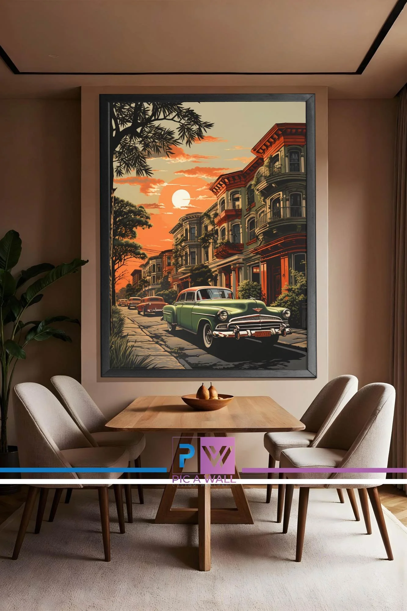 A dining room with a large framed painting of a sunset city street scene featuring vintage cars and Victorian-style buildings, surrounded by chairs and a wooden table with a bowl of pears.
