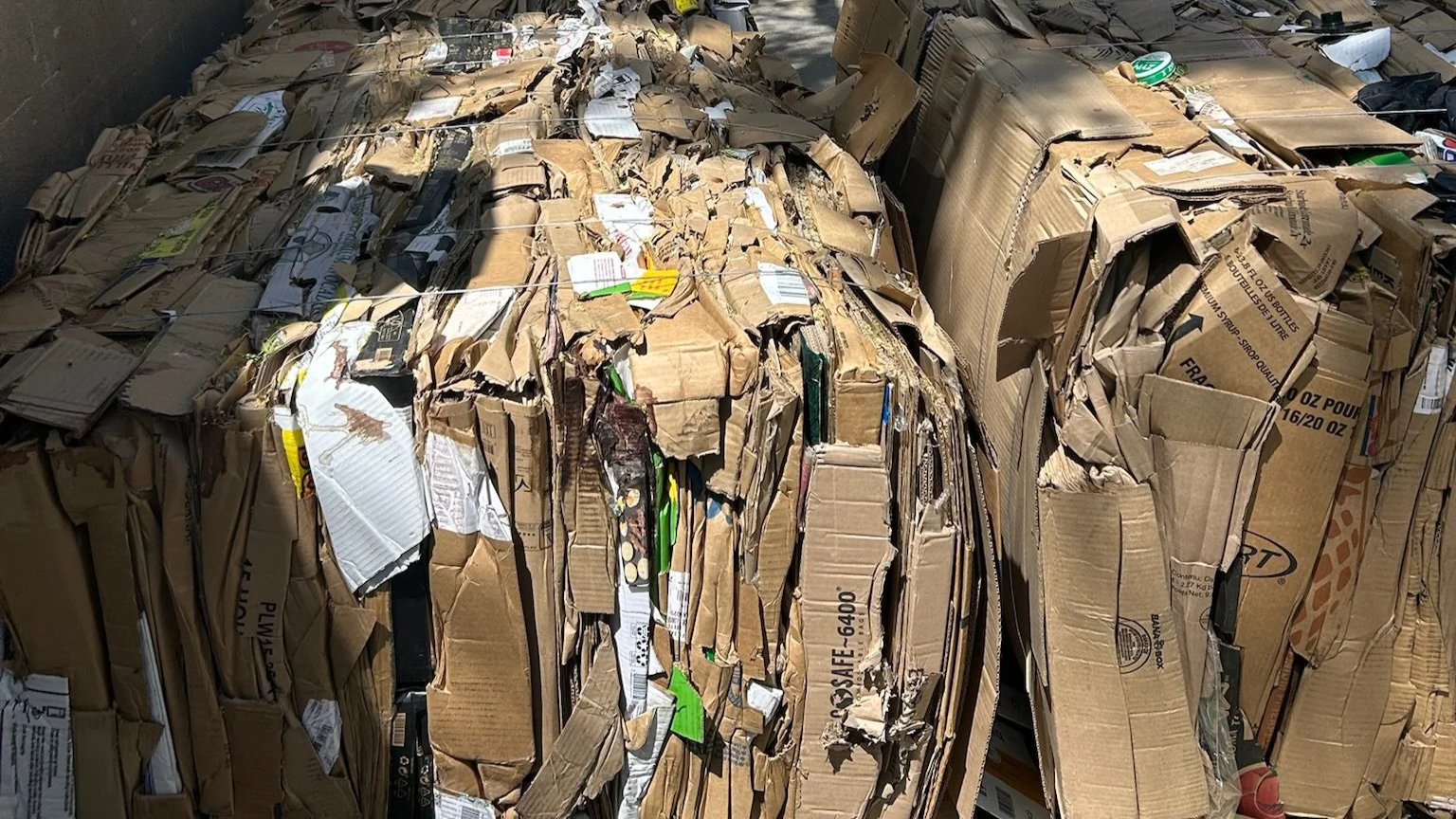 Large pile of flattened cardboard boxes and packaging materials.