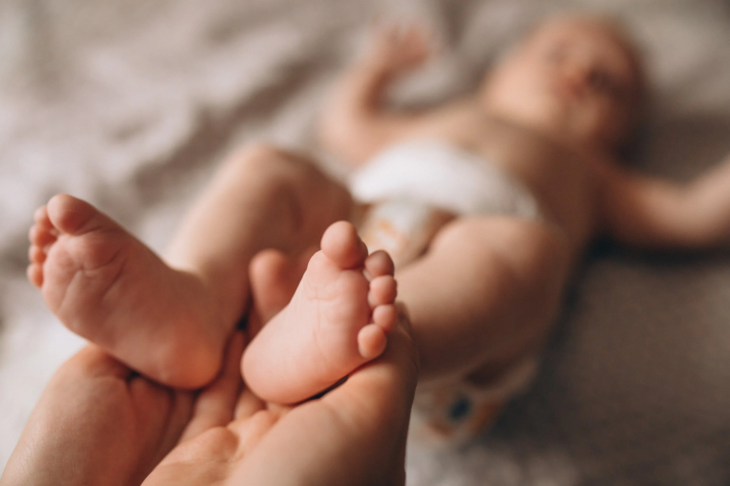 mother-holding-newborn-baby-feet.jpg
