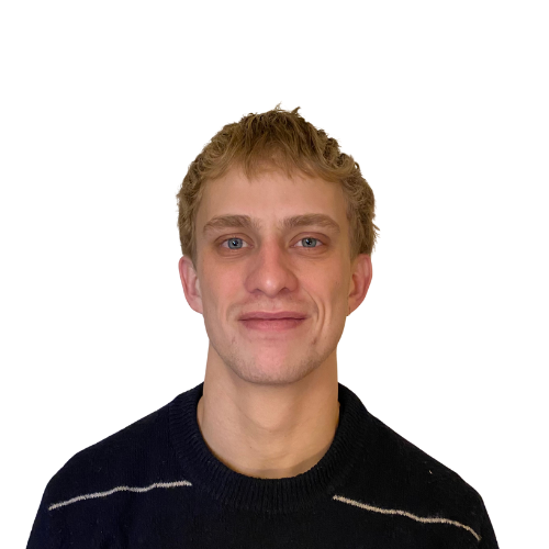 A young man with short, curly blonde hair and light skin, wearing a black sweater with white stripes on the shoulders, smiling against a plain white background.