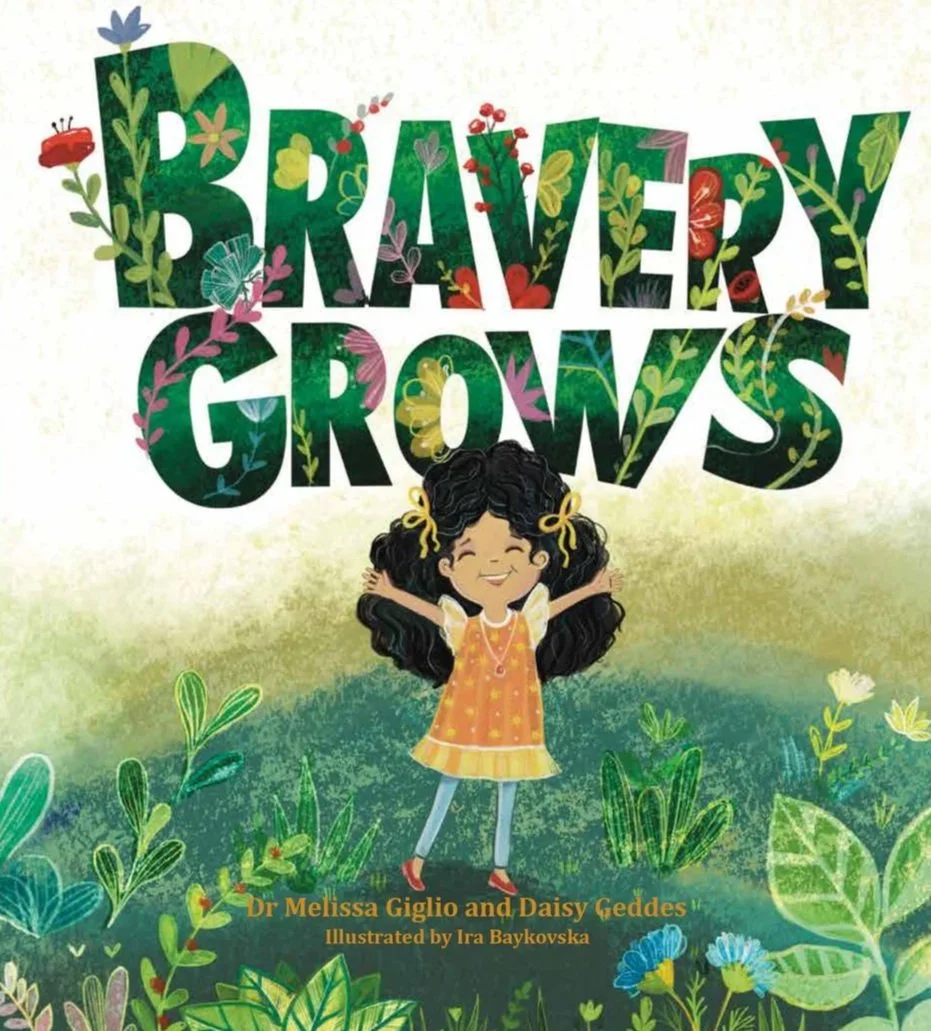 "Bravery Grows" book cover. It is a drawing of a young girl with selective mutism and she is proudly raising her hands in the air and smiling. She is surrounded by flowers and leaves.