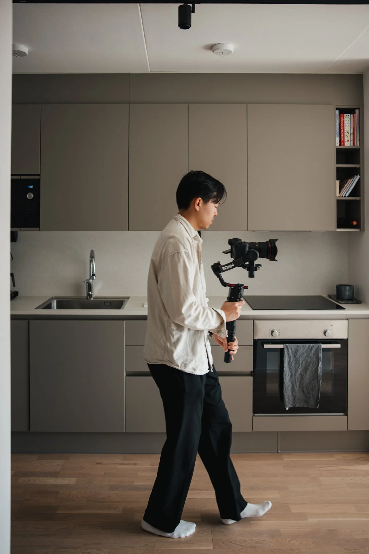 A videographer holding a camera on a gimbal