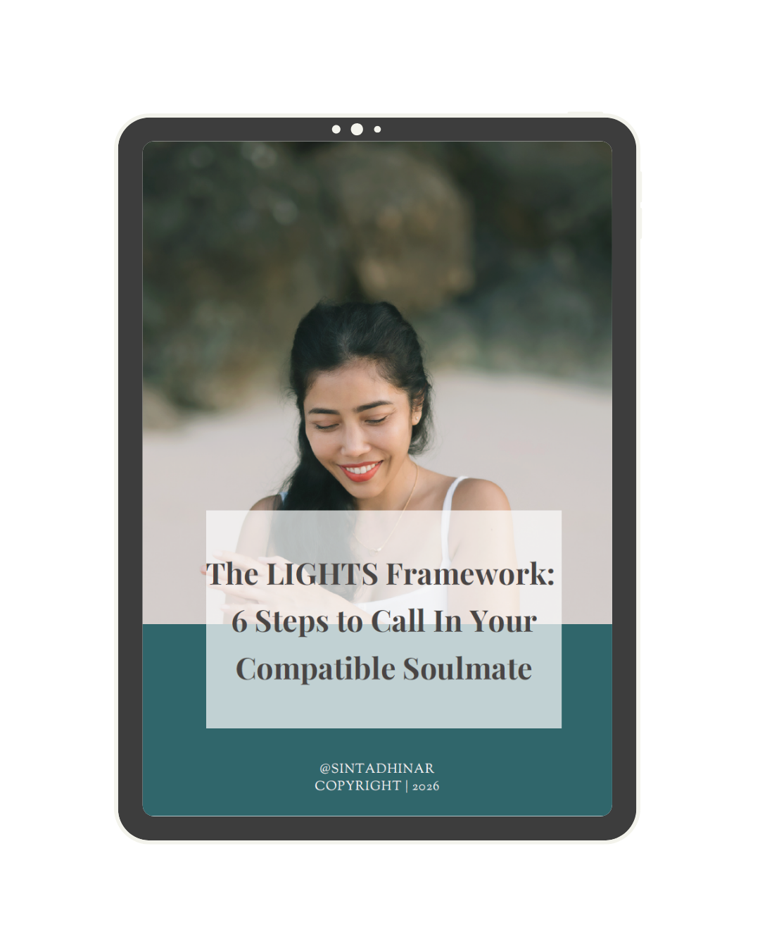 A tablet screen displaying a woman with long dark hair smiling while looking at her phone, with a beach background. The text on the screen reads 'The LIGHTS Framework: 6 Steps to Call In Your Compatible Soulmate,' and includes @SINTADHINAR, 'COPYRIGHT 2026'.
