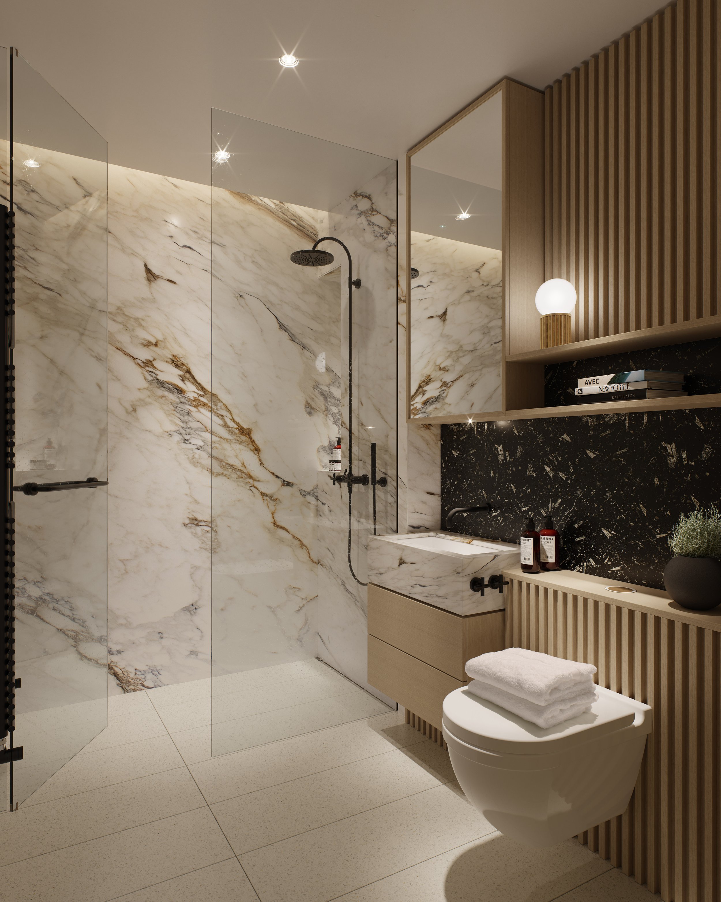 Modern bathroom with a marble shower area, glass door, and black fixtures. There is a wooden vanity with a marble sink, a mirror, and shelves with books, a lamp, and decorative items. Towels are folded on the toilet.