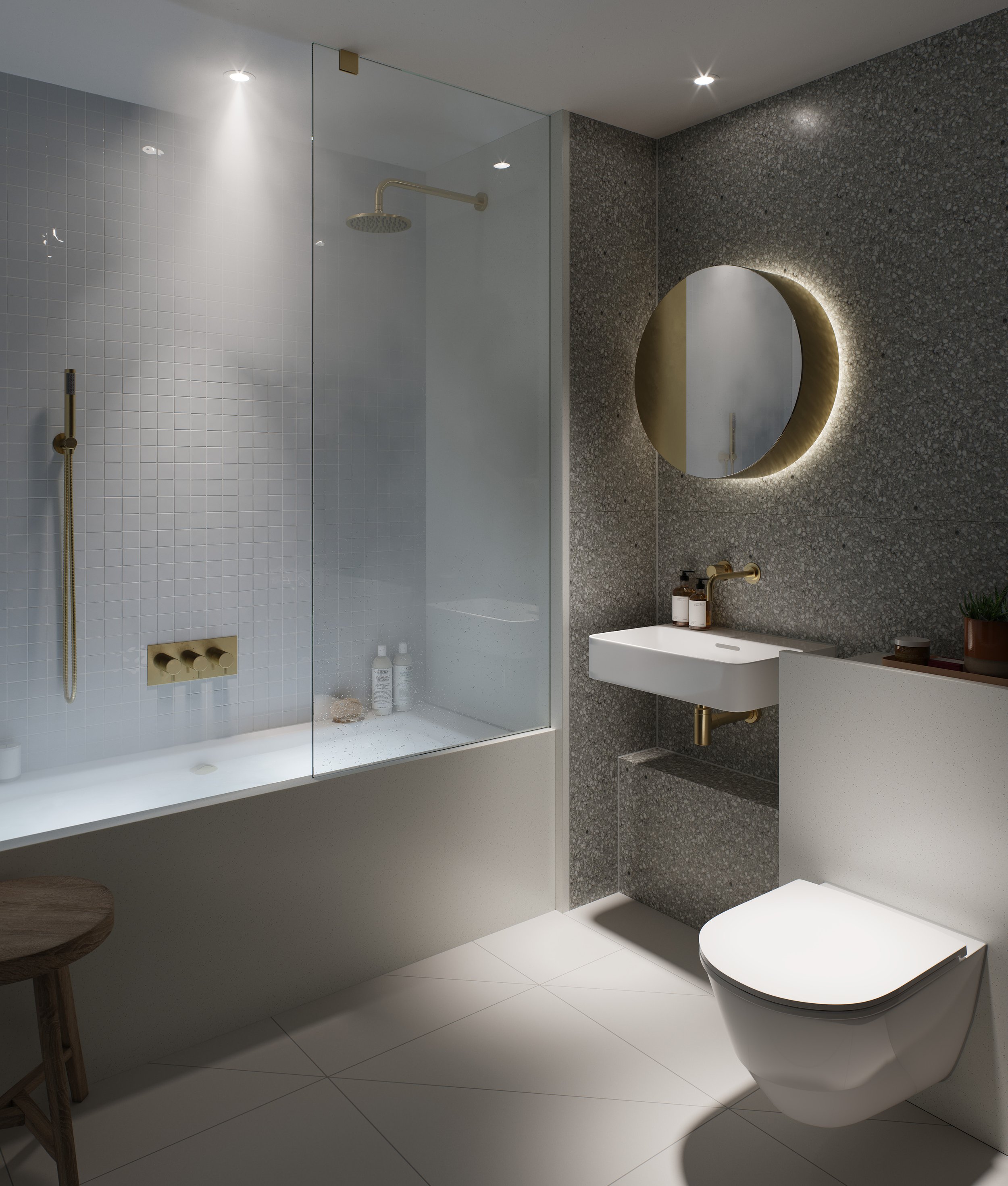 Modern bathroom with shower area, round mirror with backlighting, white sink with gold fixtures, toilet, and minimalist decor.