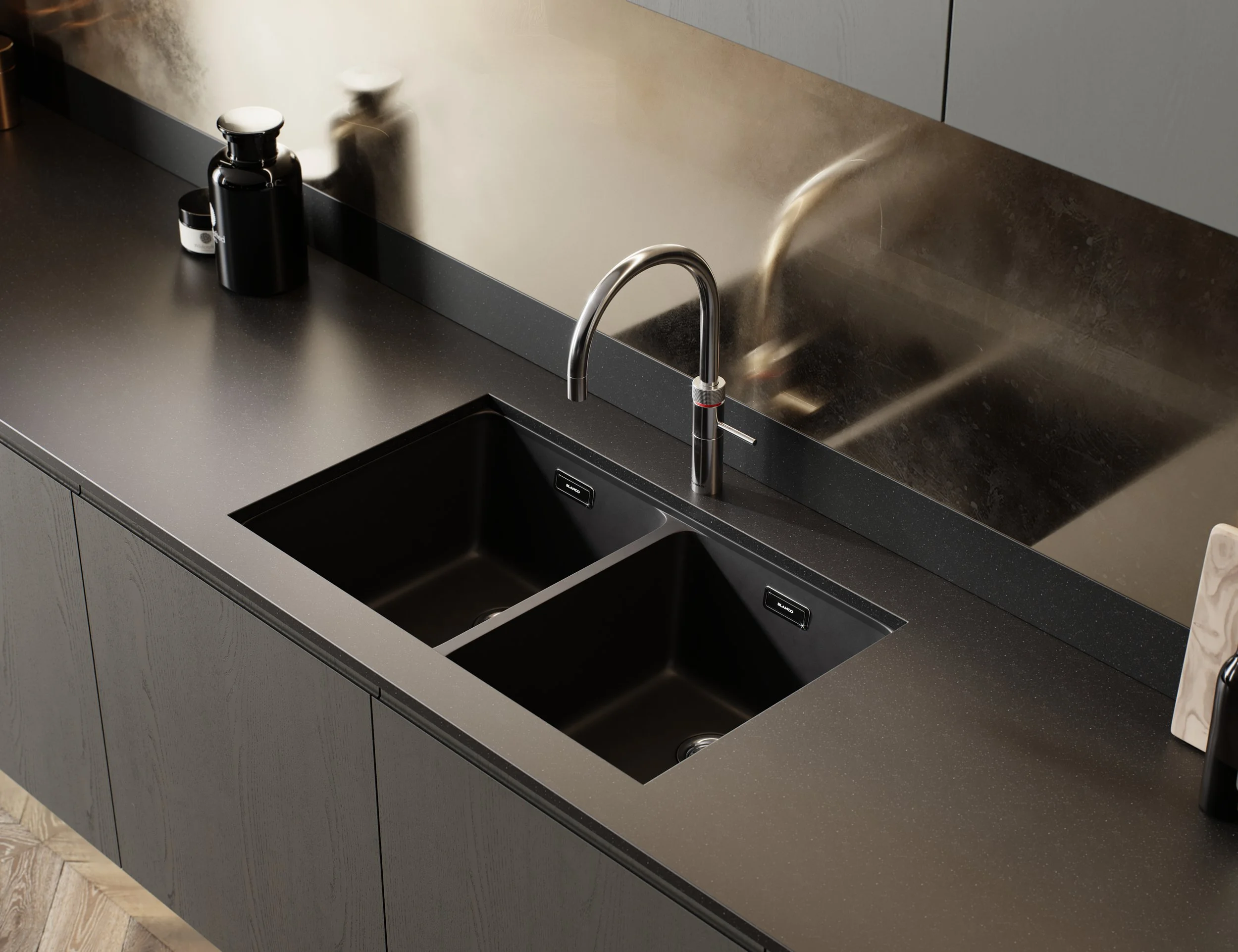 Modern kitchen countertop with a double black sink, a chrome faucet, and black bottles on the left side.