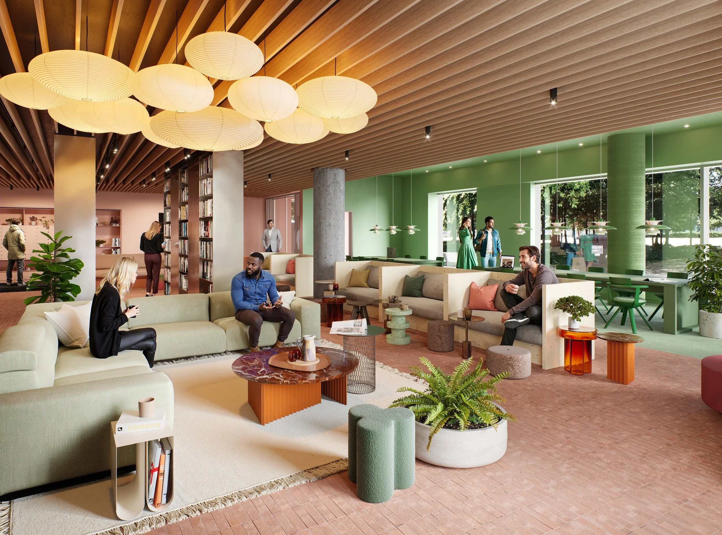 A modern, brightly-lit lounge with green and pastel-colored walls, featuring cozy seating areas with sofas, chairs, and small side tables. Several people are sitting and chatting, while others are standing and talking near the windows and bookshelves. The ceiling has a wooden slat design with hanging circular pendant lights.