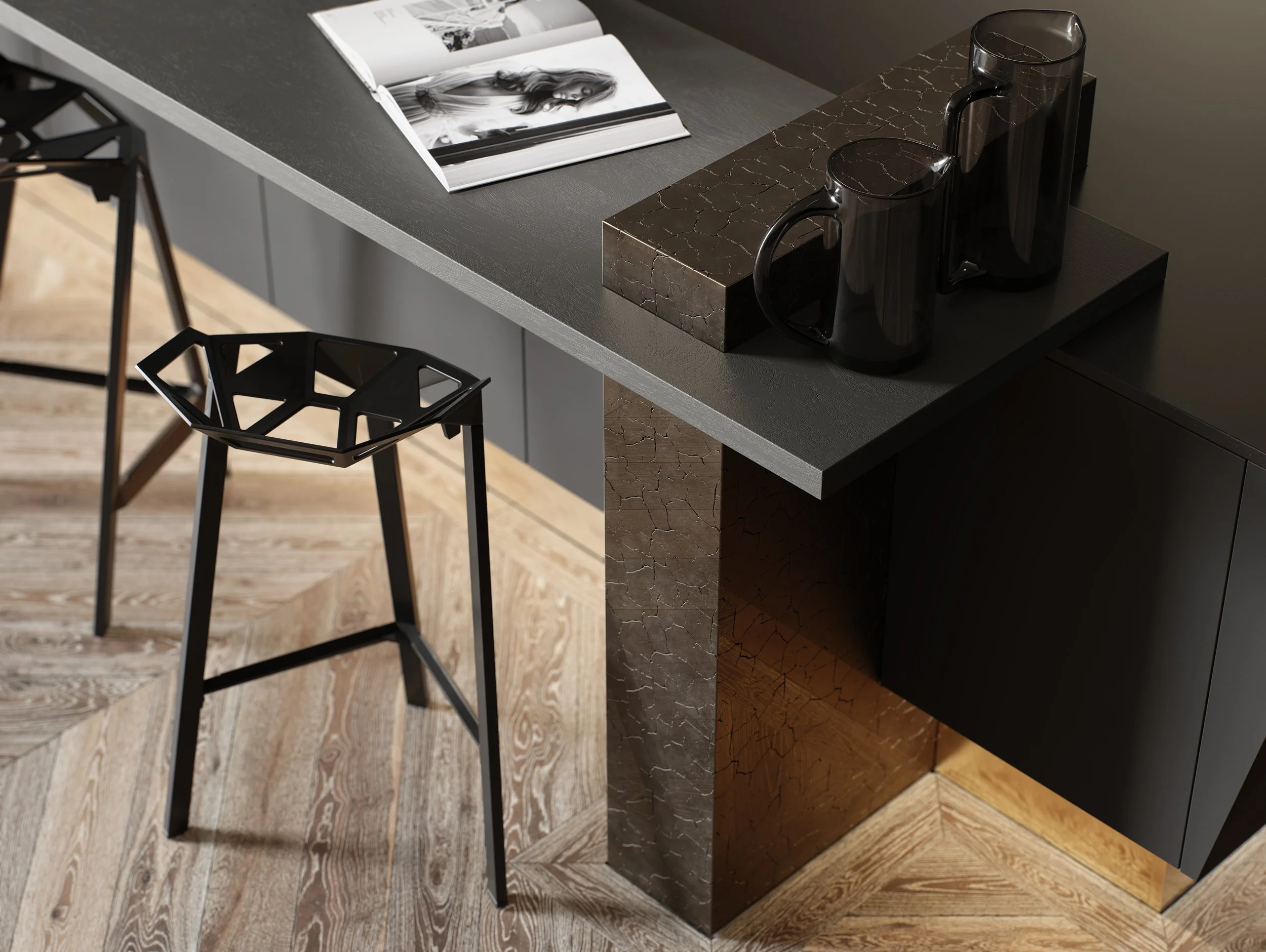 A modern black and gray kitchen island with a marble base, a black countertop, and two black coffee mugs. An open magazine is placed on the countertop.
